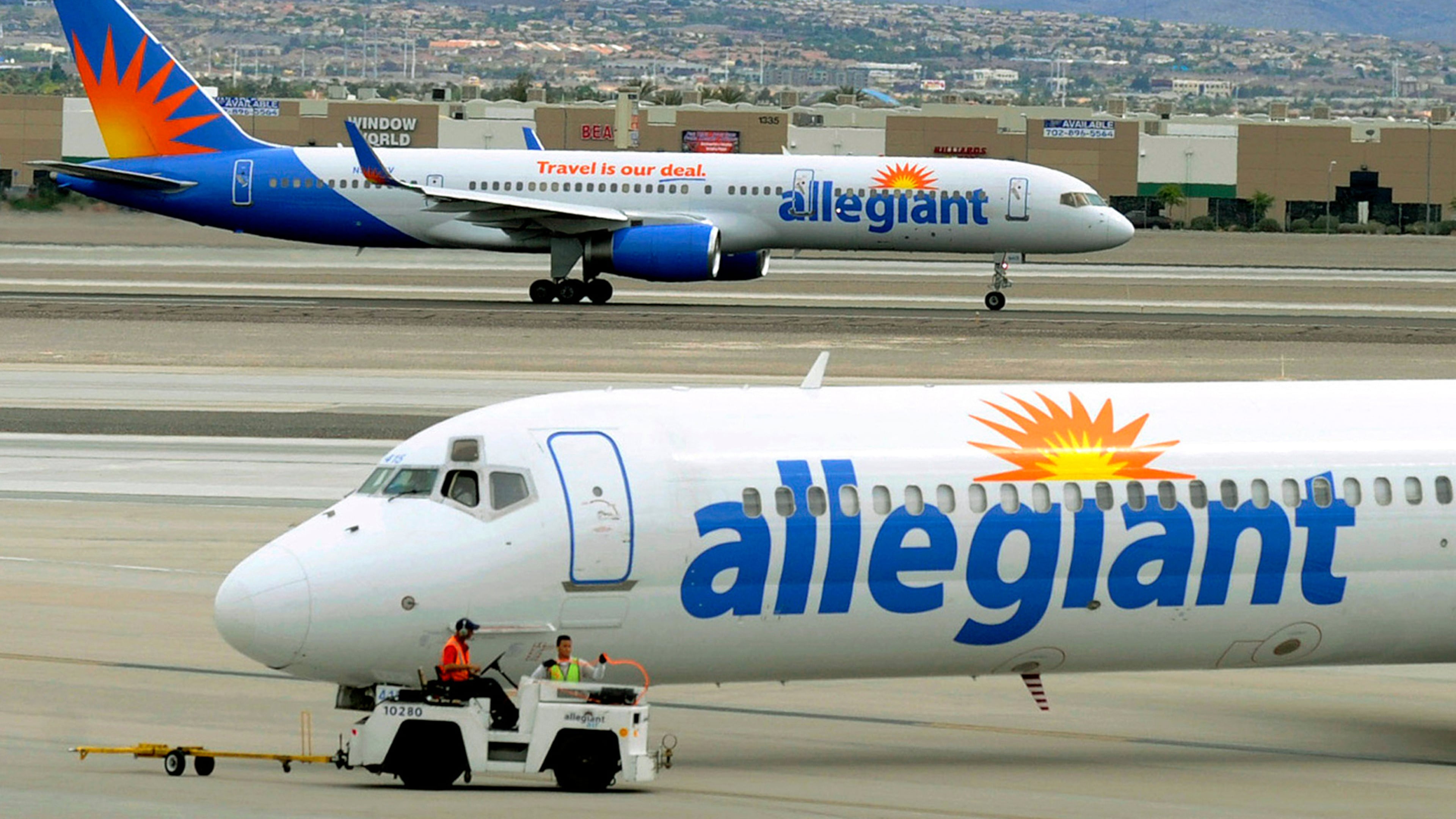 File - In this May 9, 2013, file photo, two Allegiant Air jets taxi at McCarran International Airport in Las Vegas. (AP Photo/David Becker, File)