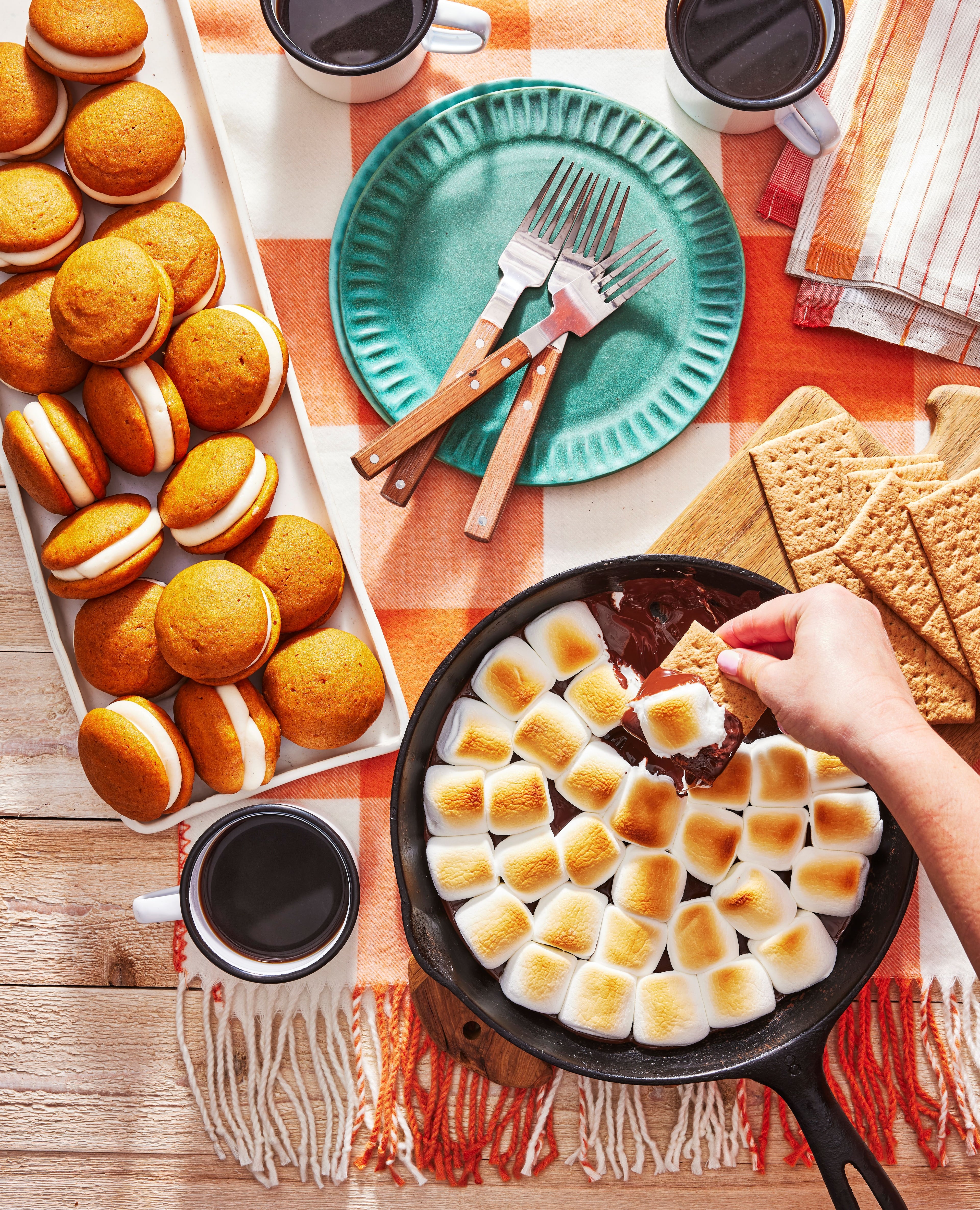 In her new cookbook, Ivy Odom writes that she makes her Pumpkin Whoopie Pies (left) every October. They are shown here with Cast Iron S’mores Dip (right), another recipe in the book. (Robbie Caponetto, courtesy of Ivy Odom/Abrams)