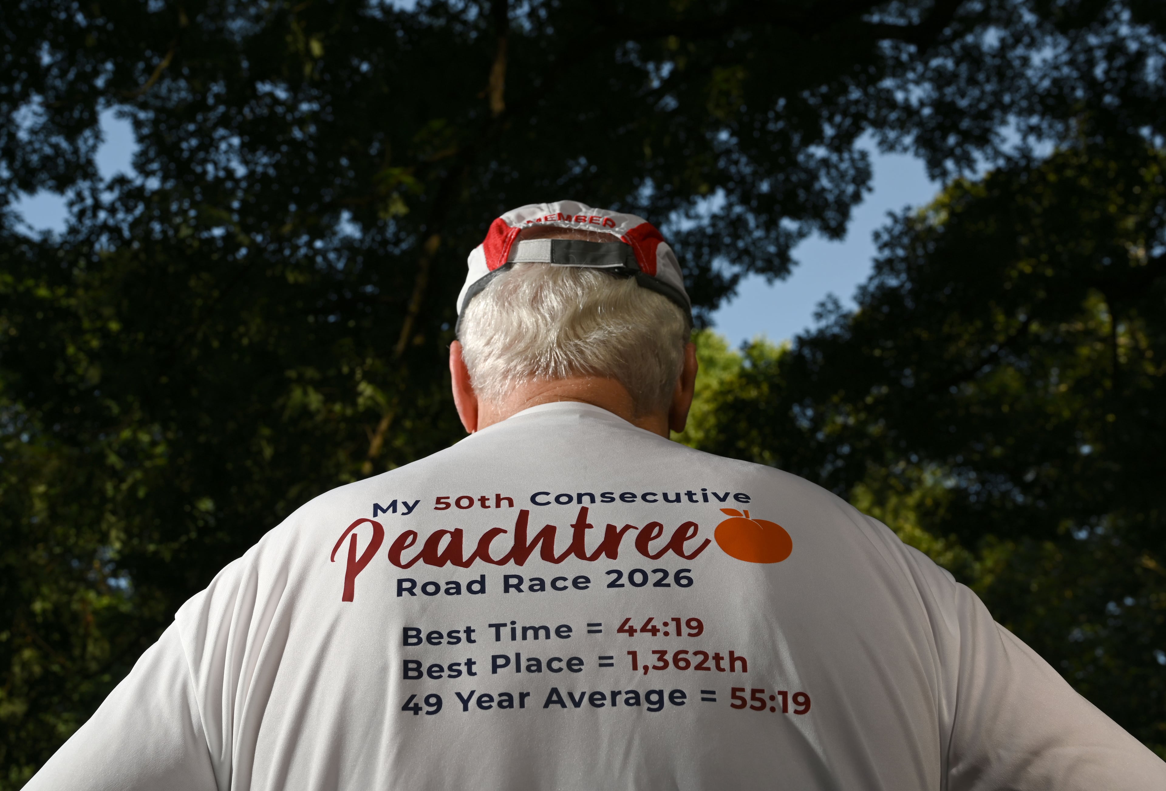 The back of Greg Gates' shirt displays a summary of his stats over his years of running the Peachtree. (Hyosub Shin/AJC)