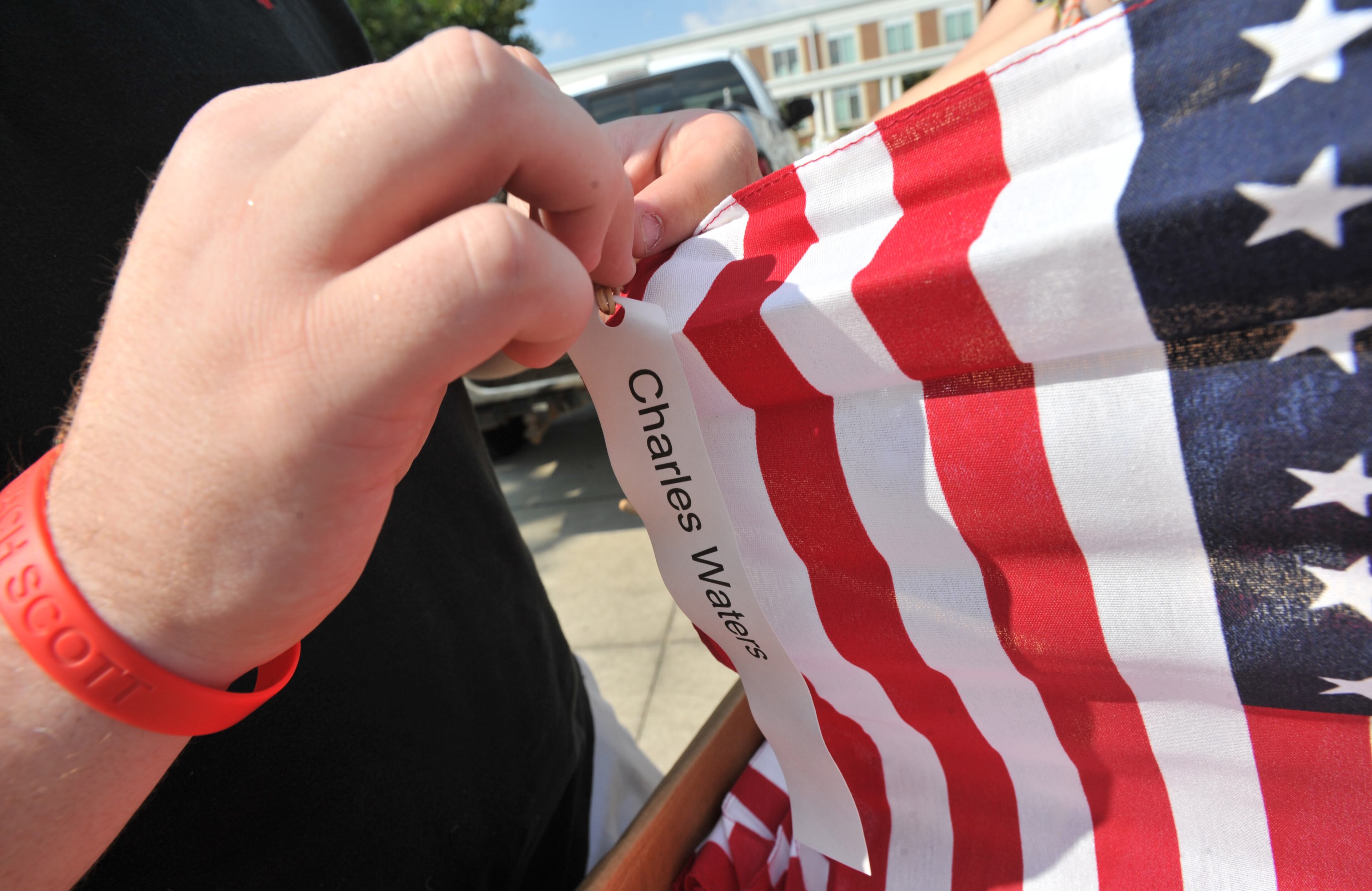 Grant Middleton, 17, attaches a name tag to one of 2,997 flags.