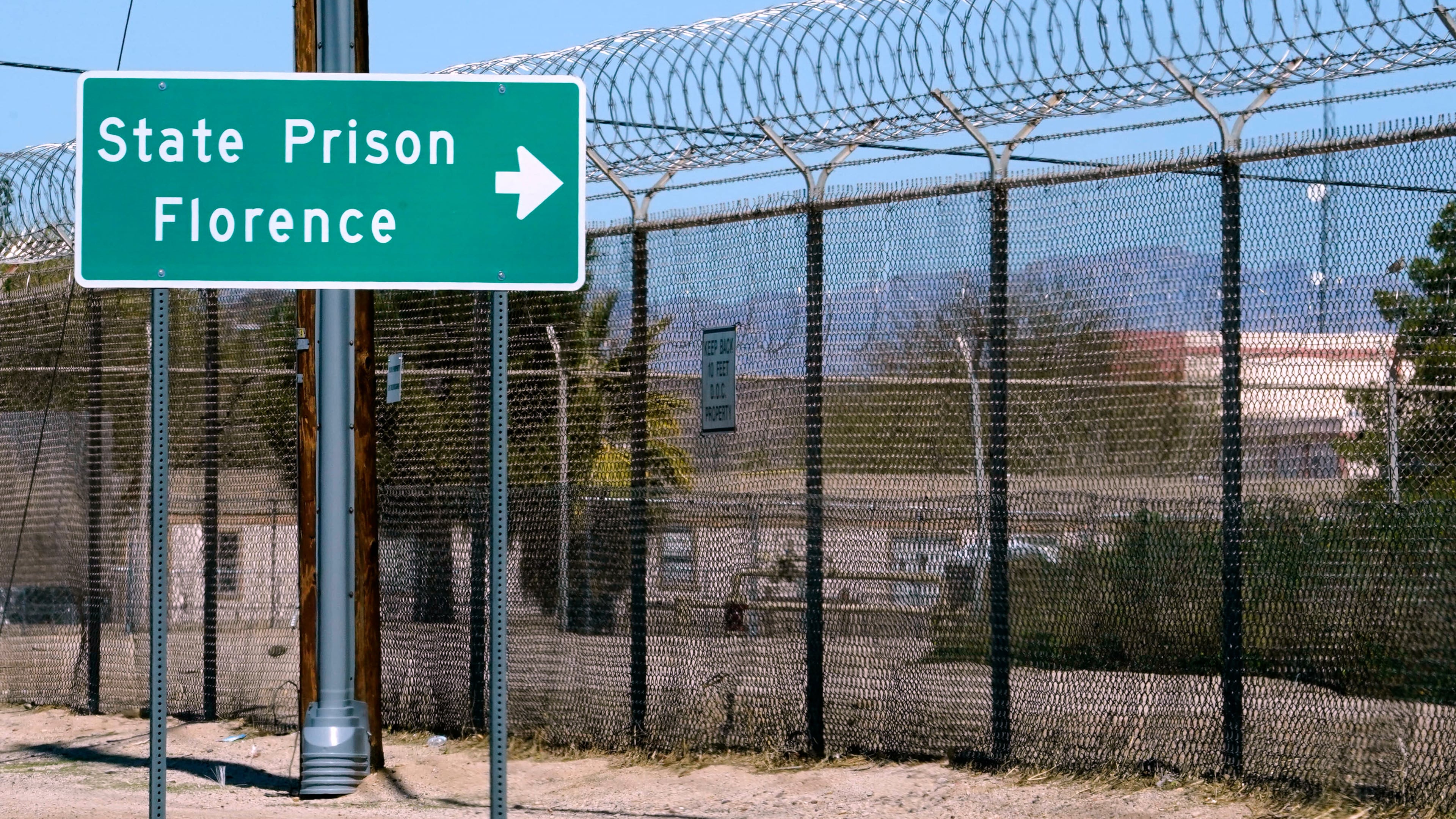 FILE - A sign points in the direction of the Arizona State Prison in Florence, Ariz., March 19, 2025. (AP Photo/Darryl Webb, File)