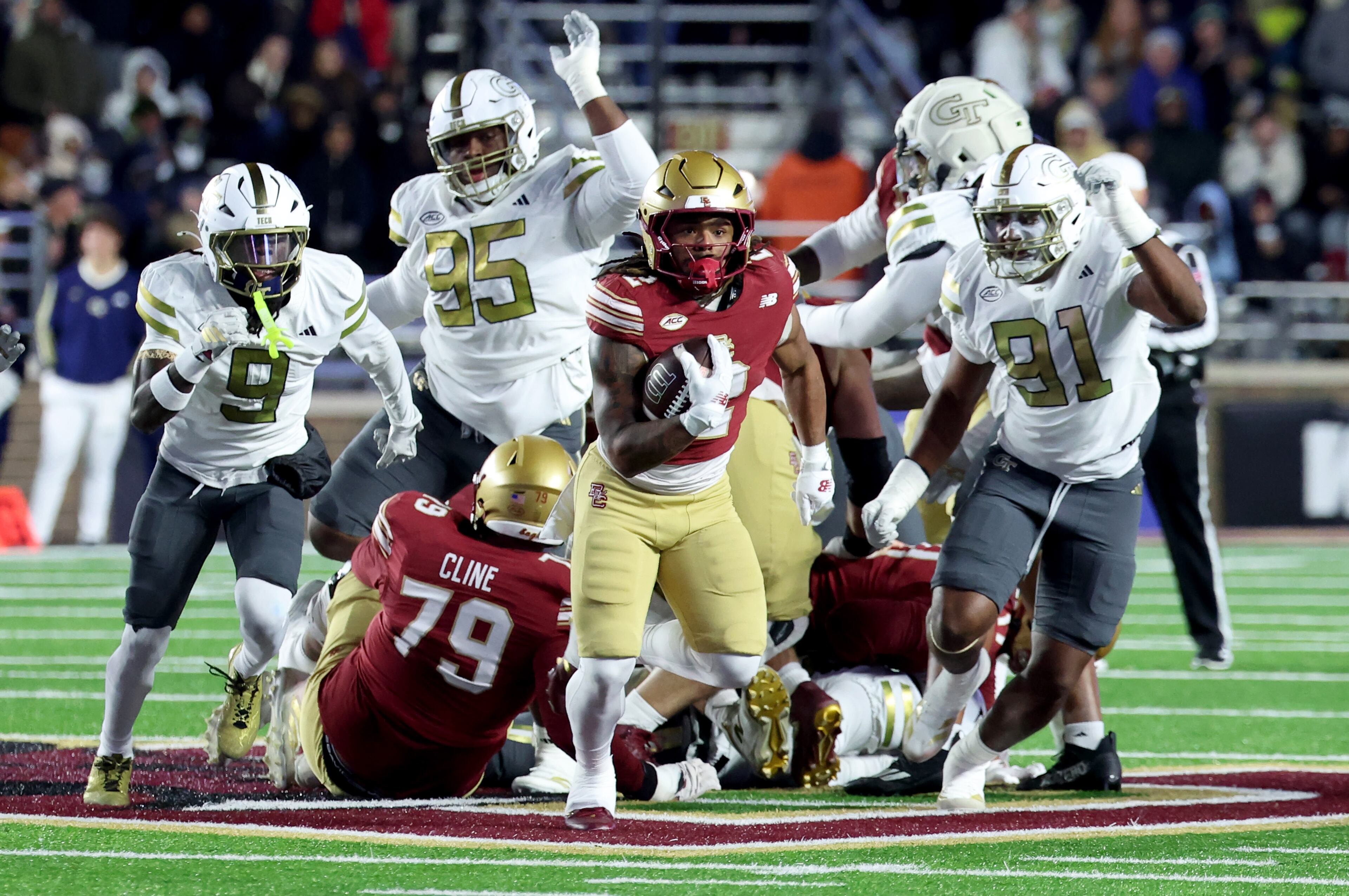 Boston College running back Turbo Richard, center, escapes Georgia Tech's defense during the second half of an NCAA college football game Saturday, Nov. 15, 2025, in Boston. (AP Photo/Mark Stockwell)