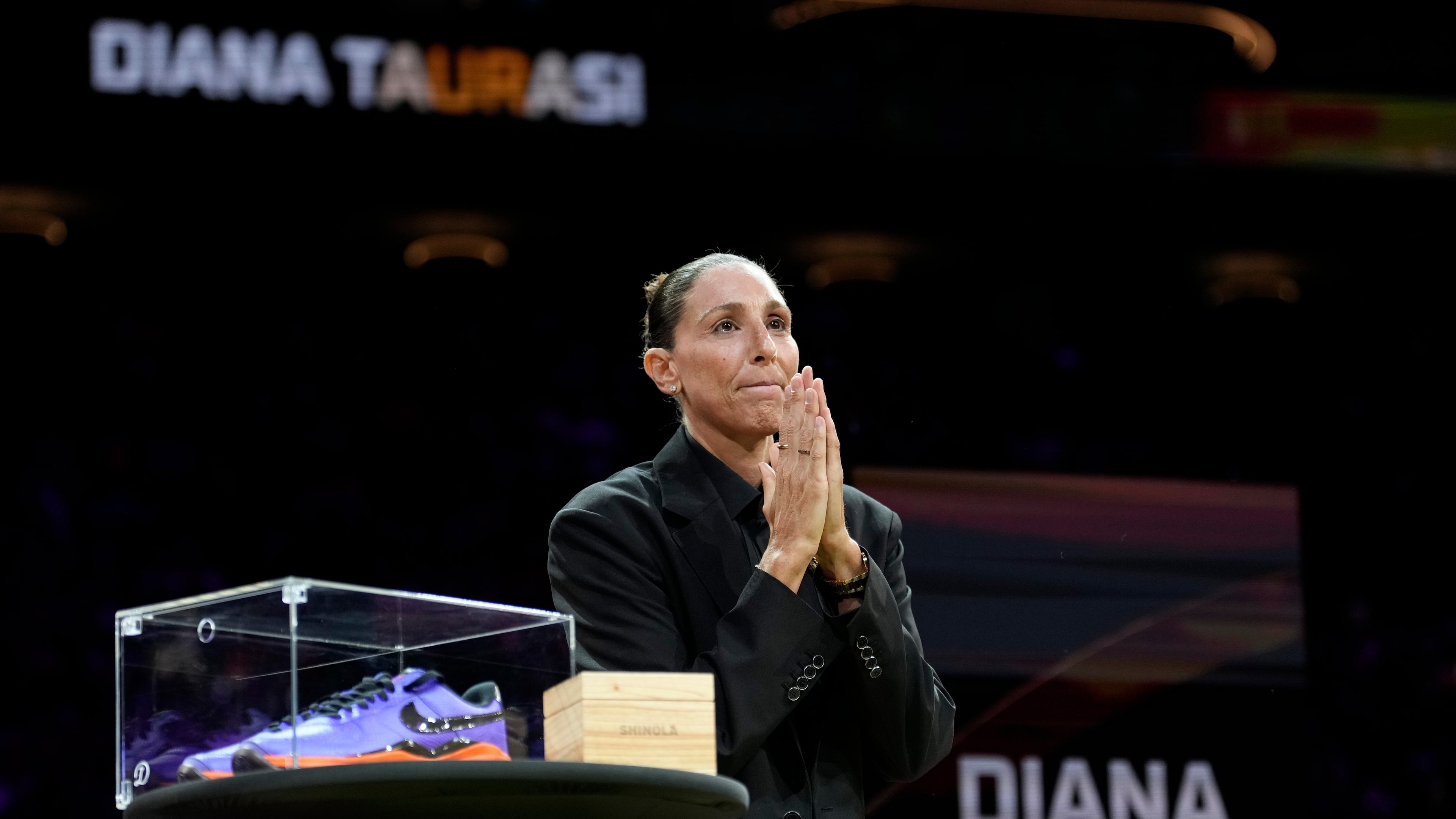 Retired WNBA Phoenix Mercury basketball player Diana Taurasi acknowledges the cheering crowd as she is honored during a halftime Ring of Honor ceremony Sunday, Aug. 16, 2026, in Phoenix. (AP Photo/Ross D. Franklin)