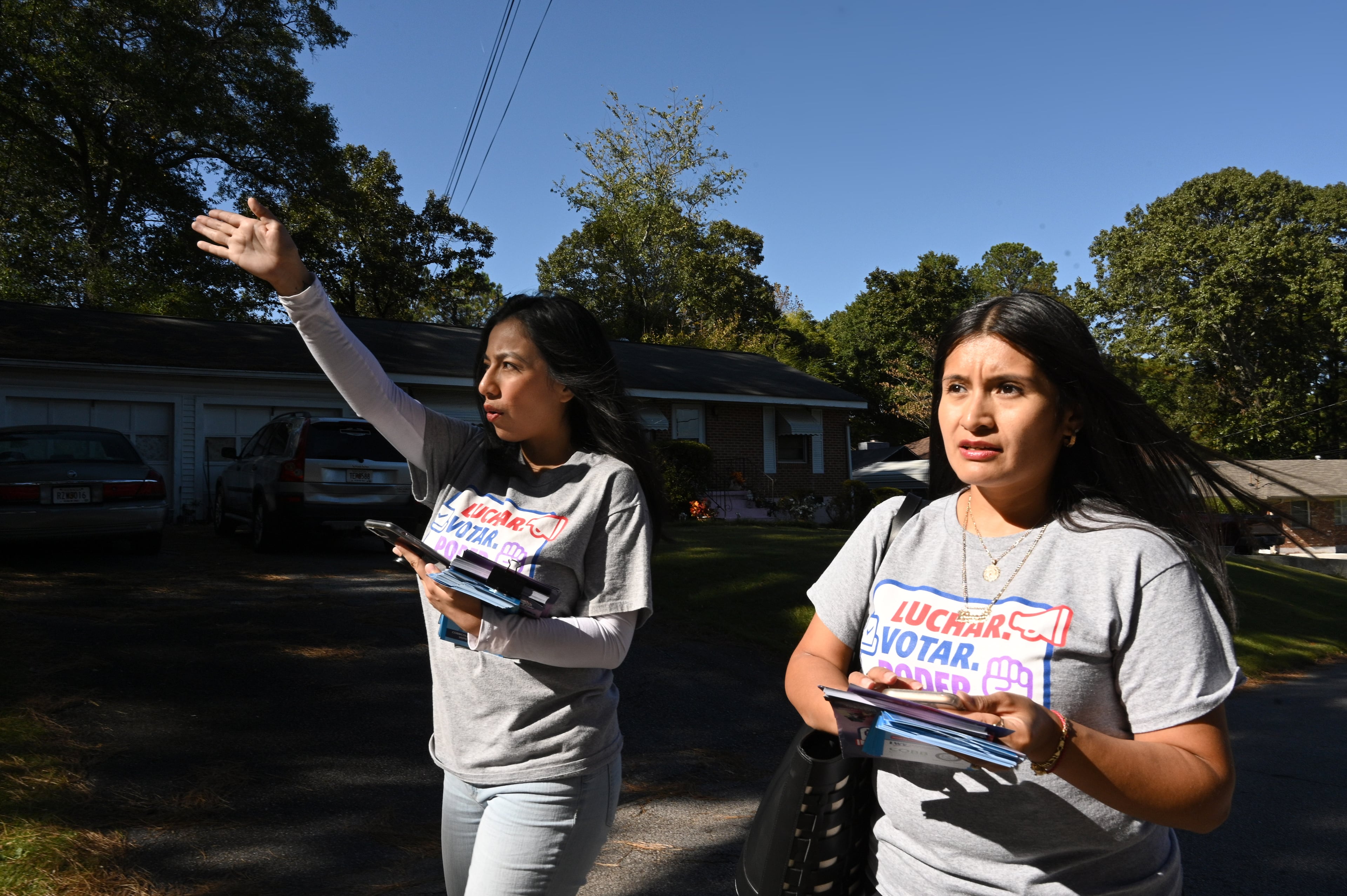 Bryna Jimenez (left) and Vanessa Jasso, both with GALEO, canvass for Latino voters in Forest Park. The group’s mission is to increase civic engagement and leadership of the Latino and Hispanic community across Georgia. (Hyosub Shin/AJC 2022)