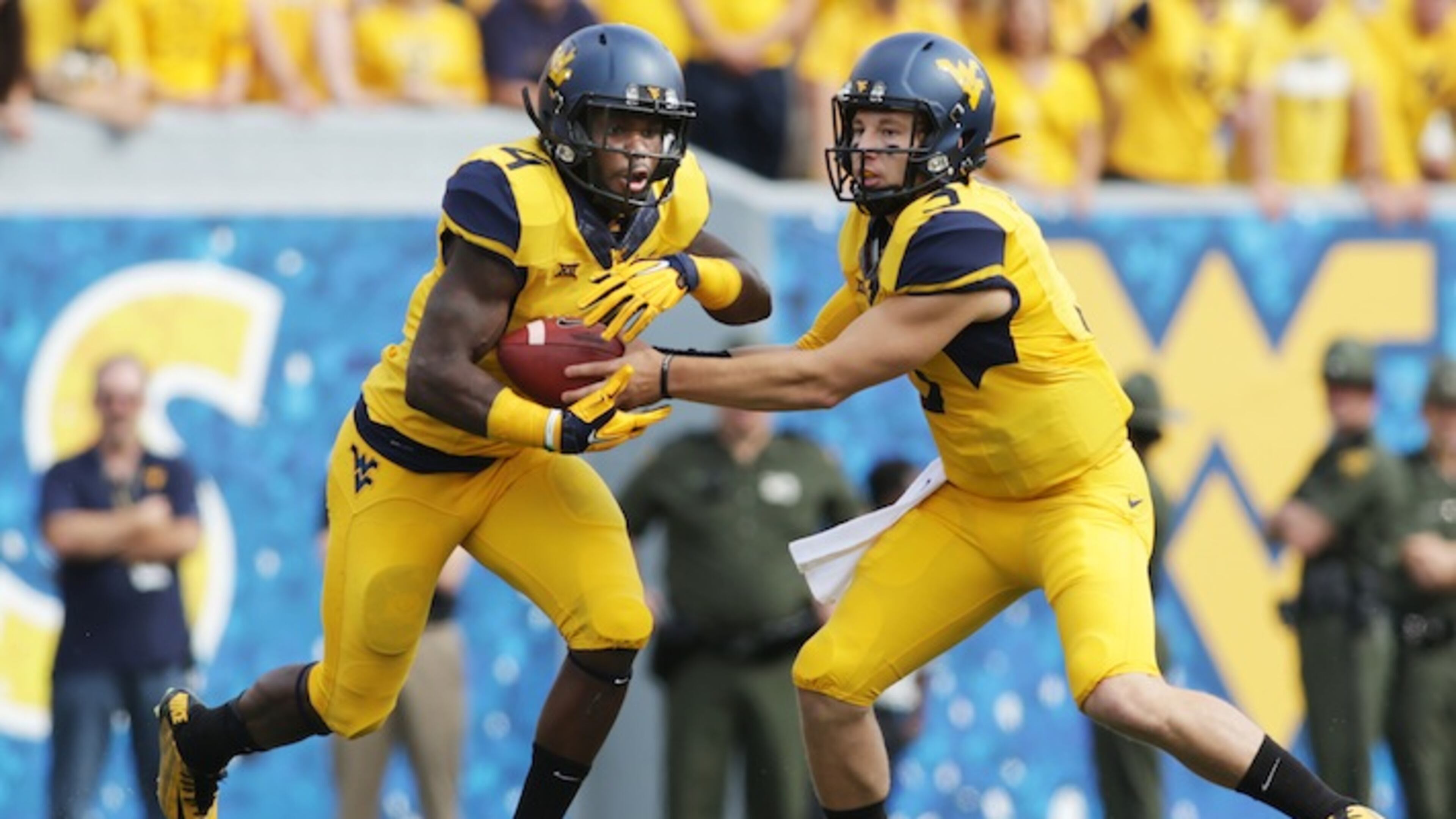West Virginia running back Wendell Smallwood (4) West Virginia quarterback Skyler Howard (3) during the first half/ second half of a NCAA college football game, Saturday, Sept. 26, 2015, in Morgantown, W.Va. (AP Photo/Raymond Thompson)