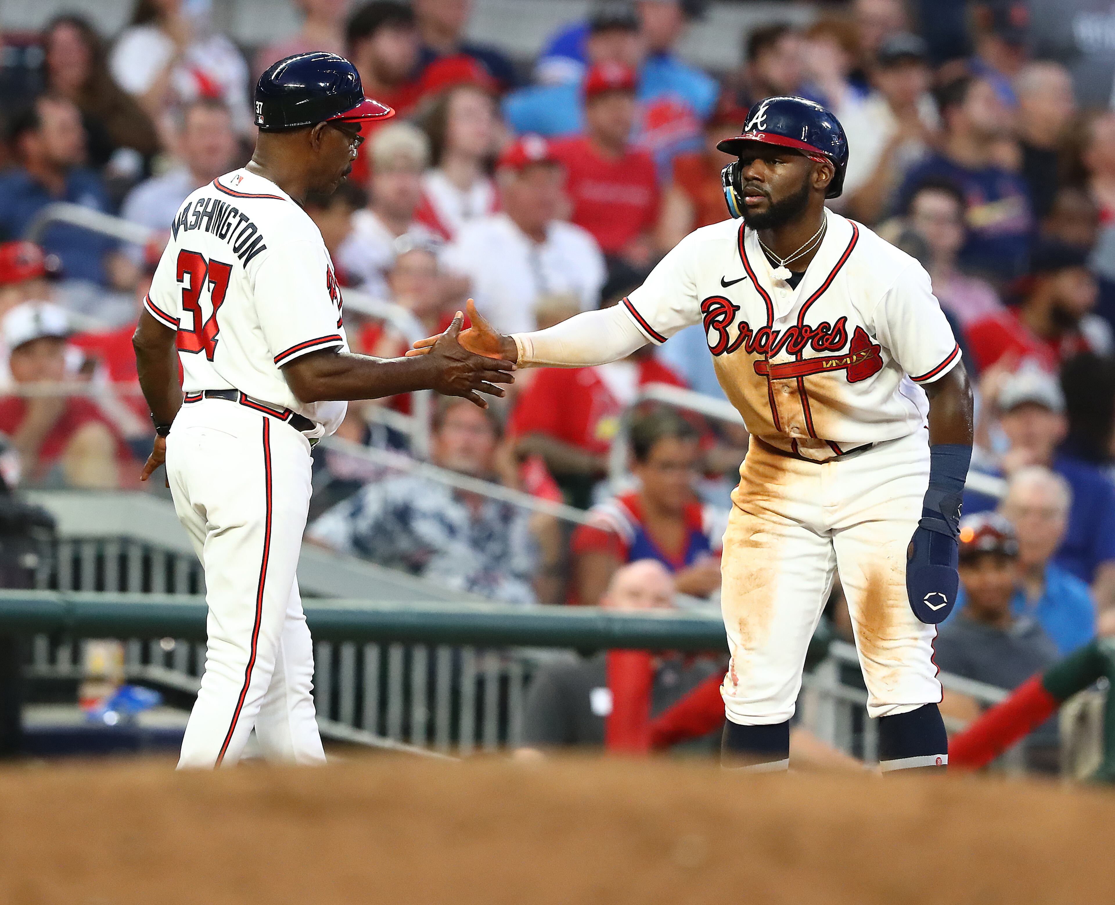 Braves outfielder Michael Harris gets five from third base coach Ron Washington after stealing third base against the St. Louis Cardinals during the fourth inning in a MLB baseball game on Tuesday, July 5, 2022, in Atlanta. “Curtis Compton / Curtis.Compton@ajc.com”