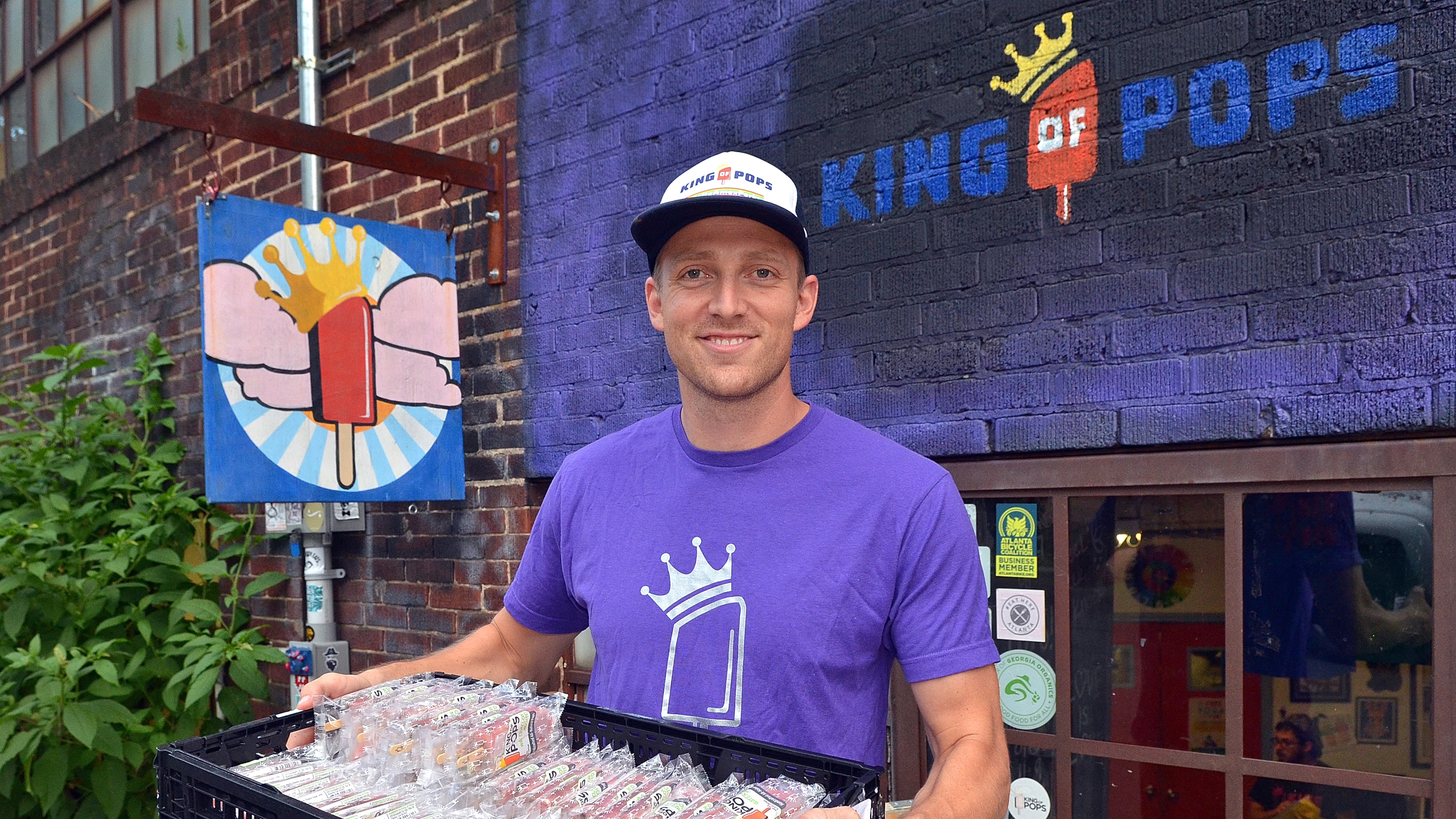 King of Pops co-owner Steven Carse holds a tray of frozen pops outside the company’s Inman Park production facility. The company announced Friday that the company is suspending production in South Carolina after the FDA found “serious violations” at its facility.