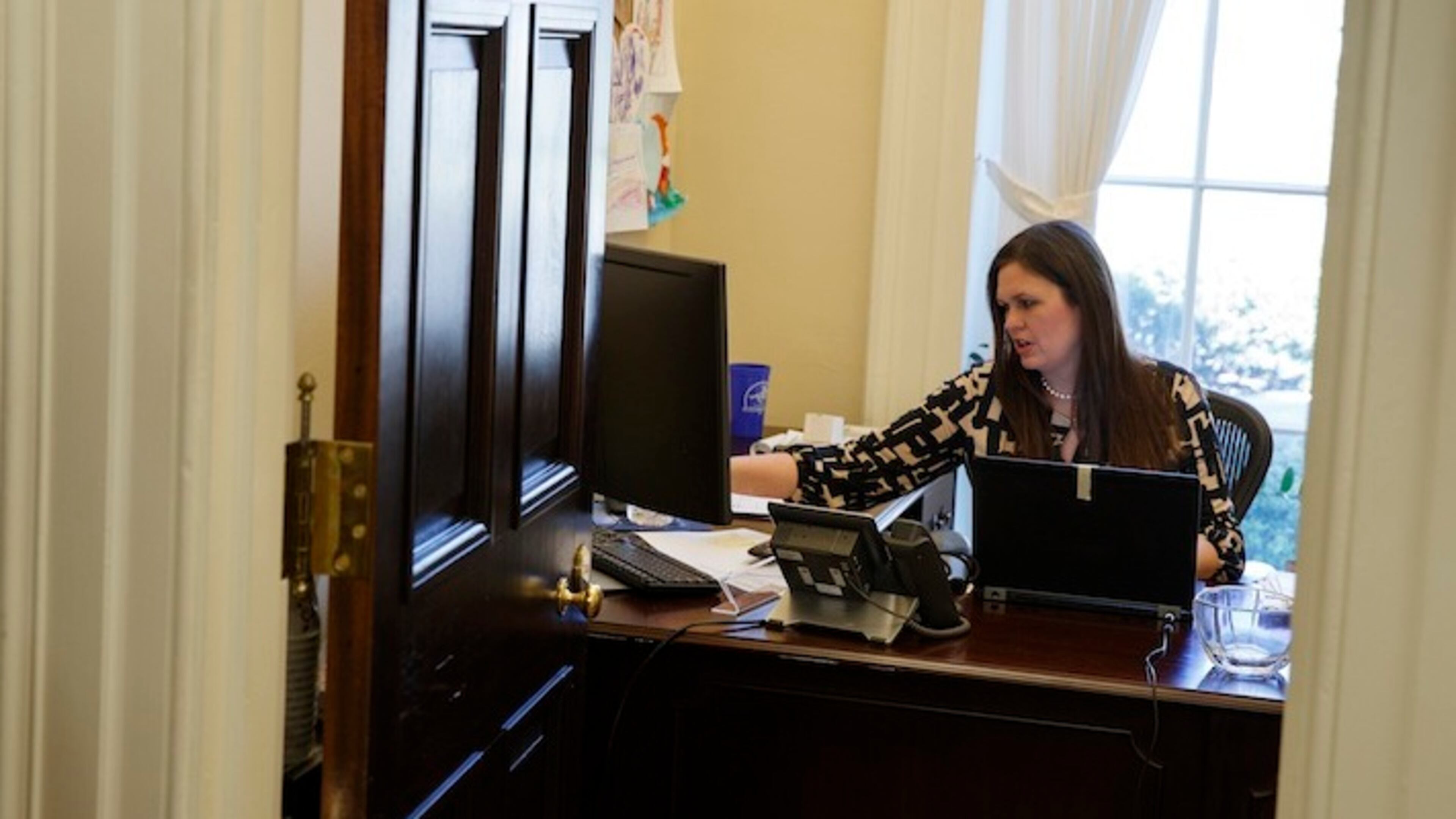In this March 8, 2017, photo, White House deputy press secretary Sarah Huckabee Sanders works in her office at the White House in Washington. The 34-year-old spokeswoman for President Donald Trump was schooled in hardscrabble politics — and down-home rhetoric — from a young age by her father, folksy former Arkansas Gov. Mike Huckabee. Her way with a zinger, and her unshakable loyalty to an often unpredictable boss, is a big reason why the deputy press secretary is a rising star in Trump's orbit. (AP Photo/Evan Vucci)
