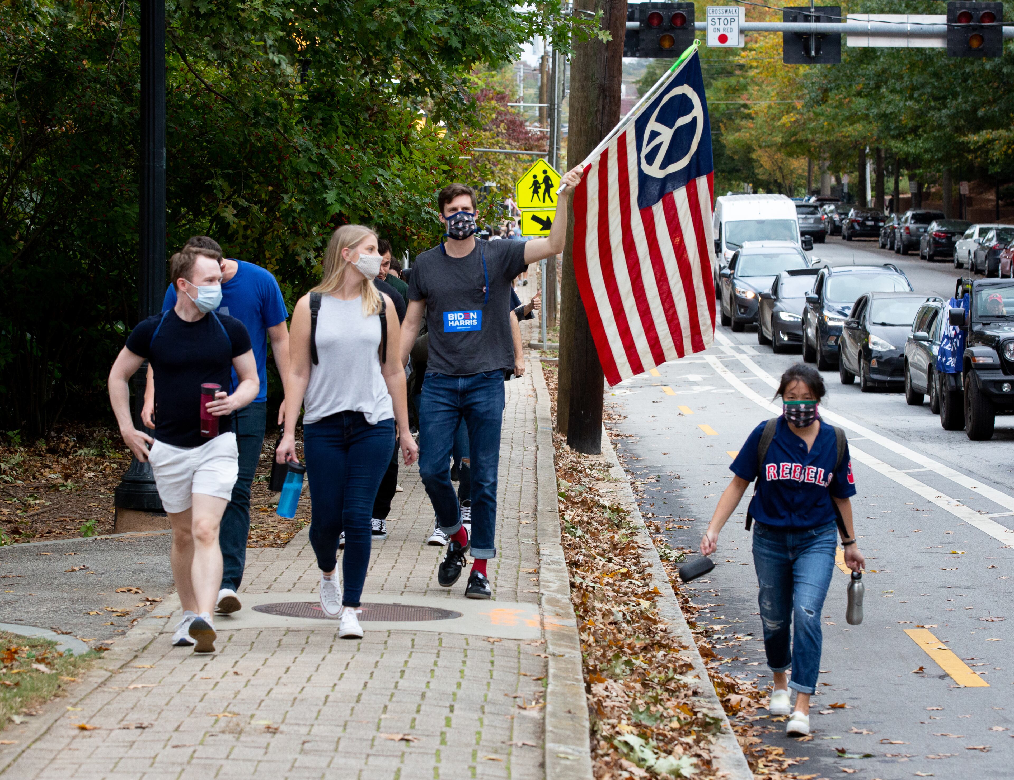 People celebrate after the election was called for Joe Biden near Piedmont Park on November 7, 2020. STEVE SCHAEFER / SPECIAL TO THE AJC
