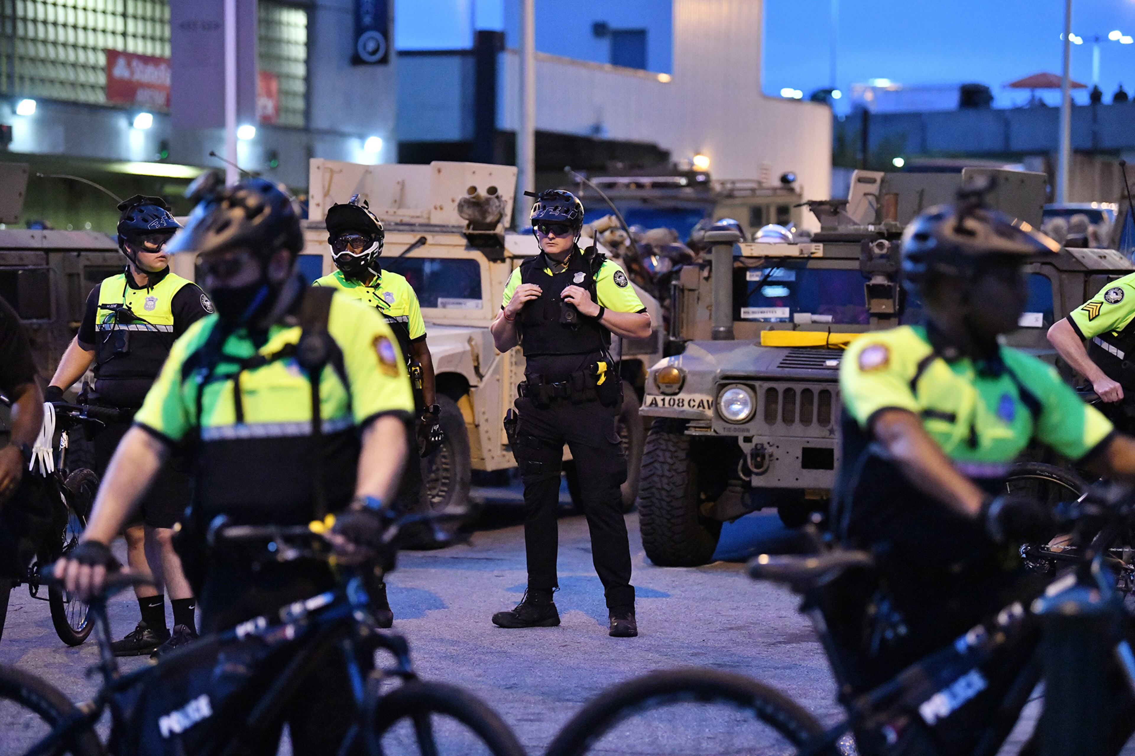 June 3, 2020 Atlanta - Georgia Army National Guard and police officers move in to enforce a 9PM curfew during the sixth consecutive day of protest against police brutality and racism at Centennial Olympic Park on Wednesday, June 3, 2020. The curfew for the city of Atlanta was extended for the next five days, going into effect at 9 p.m. Wednesday. (Hyosub Shin / Hyosub.Shin@ajc.com)