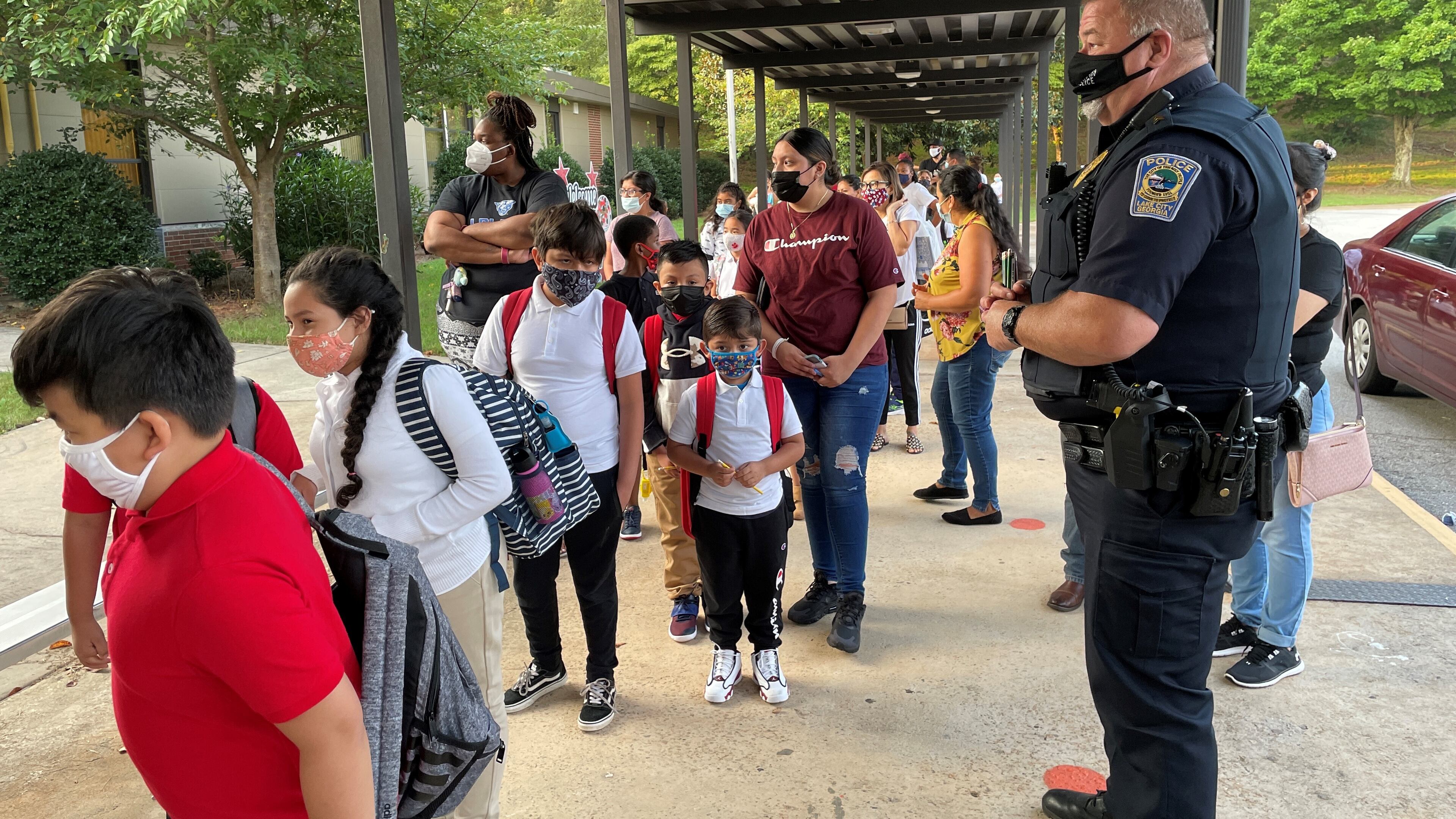 Students arrive for classes on the first day of school at Lake City Elementary School in Morrow on Aug. 2, 2021. This week, the Clayton County School District made masks optional after Gov. Brian Kemp signed into law legislation that allows parents the right to opt out of mask mandates. (Leon Stafford / AJC)