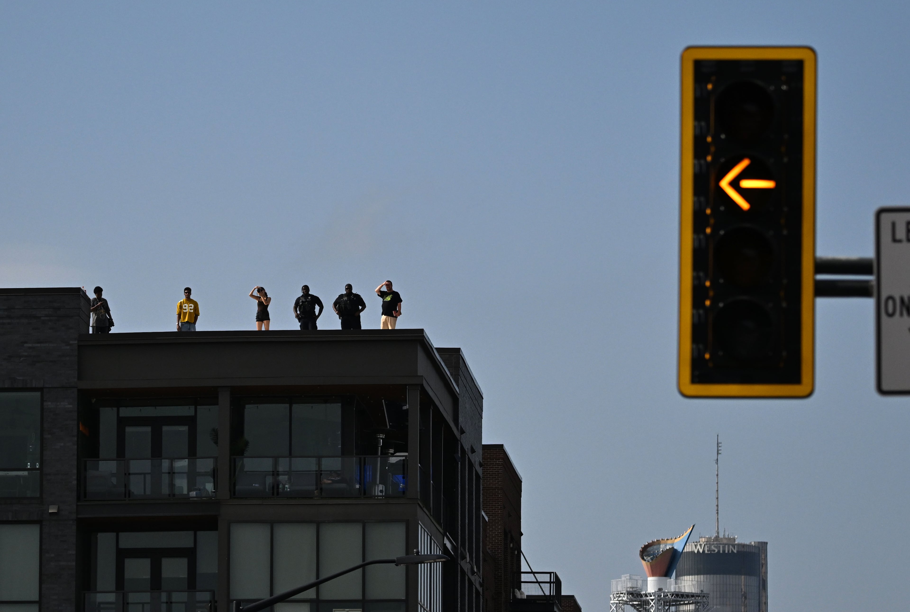 Spectators watch from a roof during the Red Bull Showrun Atlanta Presented by Ford Racing on Saturday, Aug. 1, 2026, in Atlanta. Atlanta city officials this week approved permits for the Red Bull Showrun that will allow the live motorsports demonstration event to go on as advertised along a roughly half-mile stretch of Hank Aaron Drive — a backup location after earlier plans to hold the event near Piedmont Park ran into opposition from Midtown residents. (Hyosub Shin/AJC)