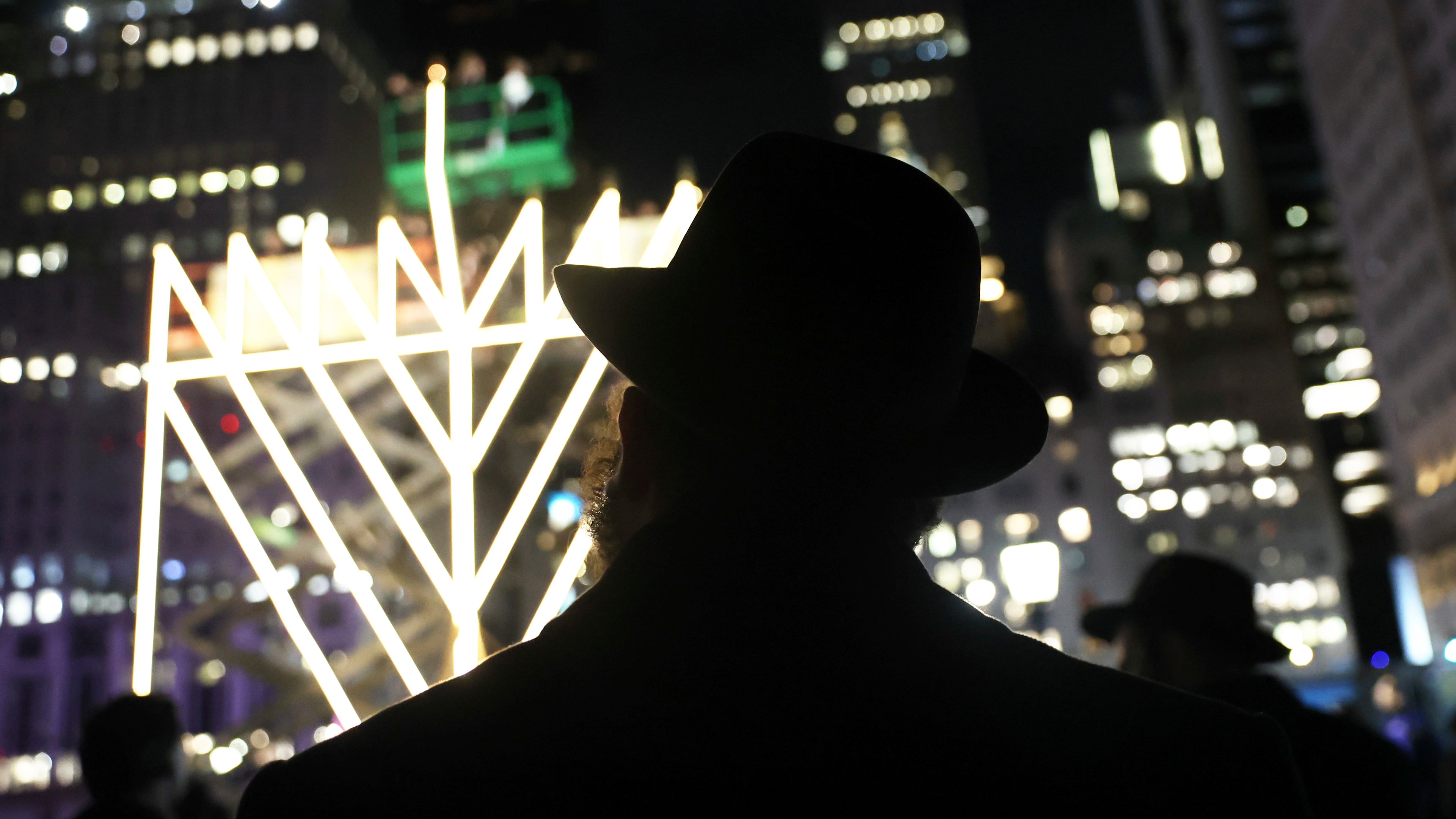 FILE - People watch the lighting of the world's largest menorah on Fifth Avenue by Central Park for the seventh night of Hanukkah, Dec. 31, 2024, in New York. (AP Photo/Heather Khalifa, File)