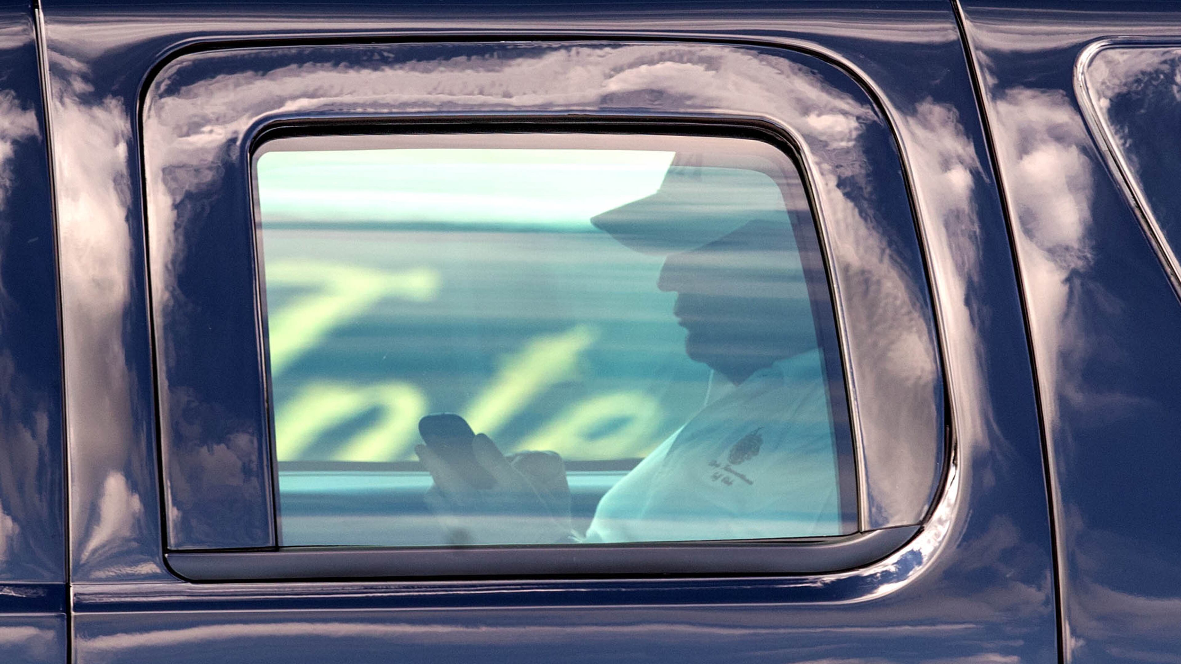 President Donald Trump works his phone after finishing a round of golf at Trump International Golf Club in West Palm Beach on Feb. 5. (Allen Eyestone / The Palm Beach Post)