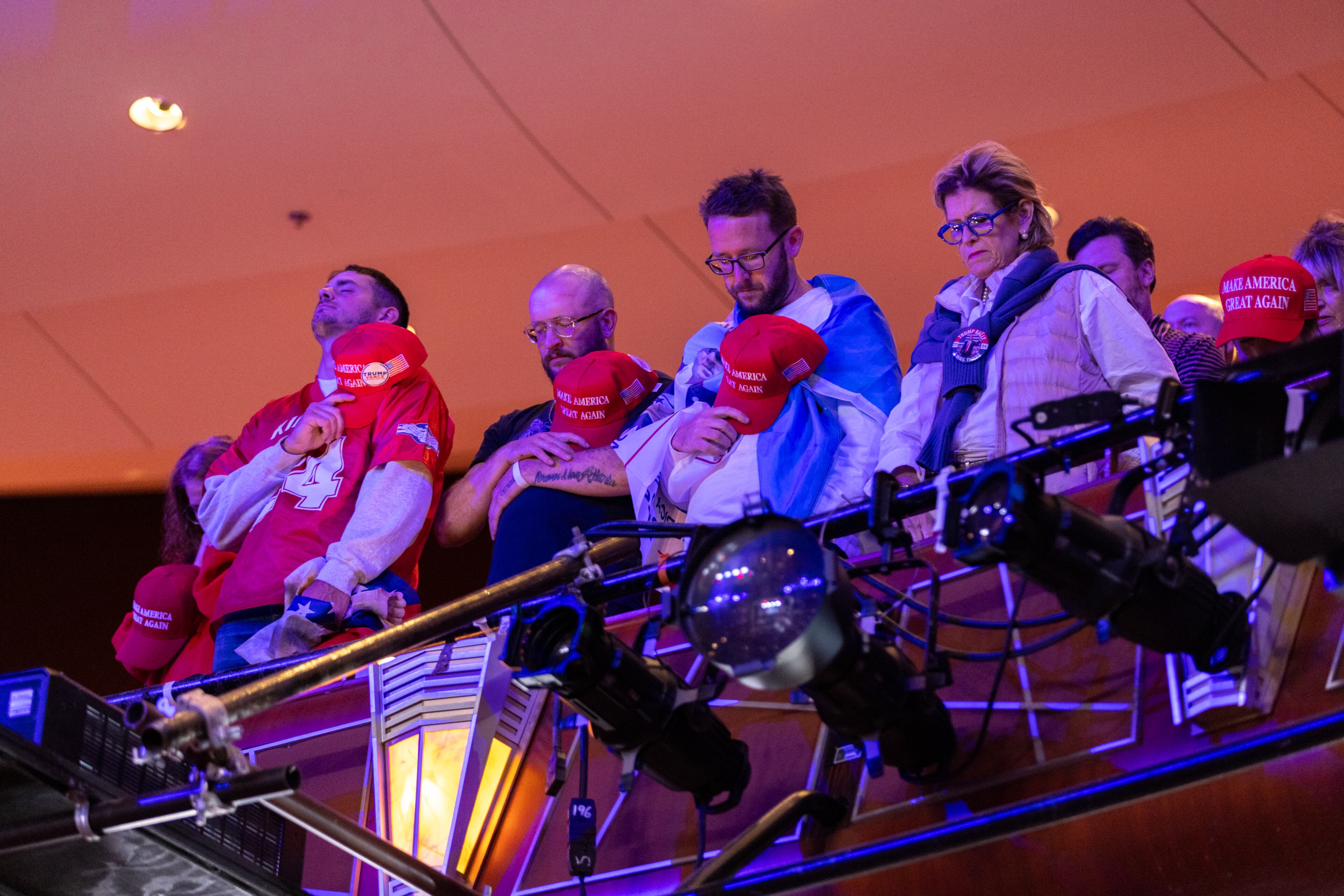 Supporters pray before Republican presidential candidate Donald Trump’s rally at Cobb Energy Performing Arts Centre in Cobb County on Tuesday, October 15, 2024. (Arvin Temkar / AJC)