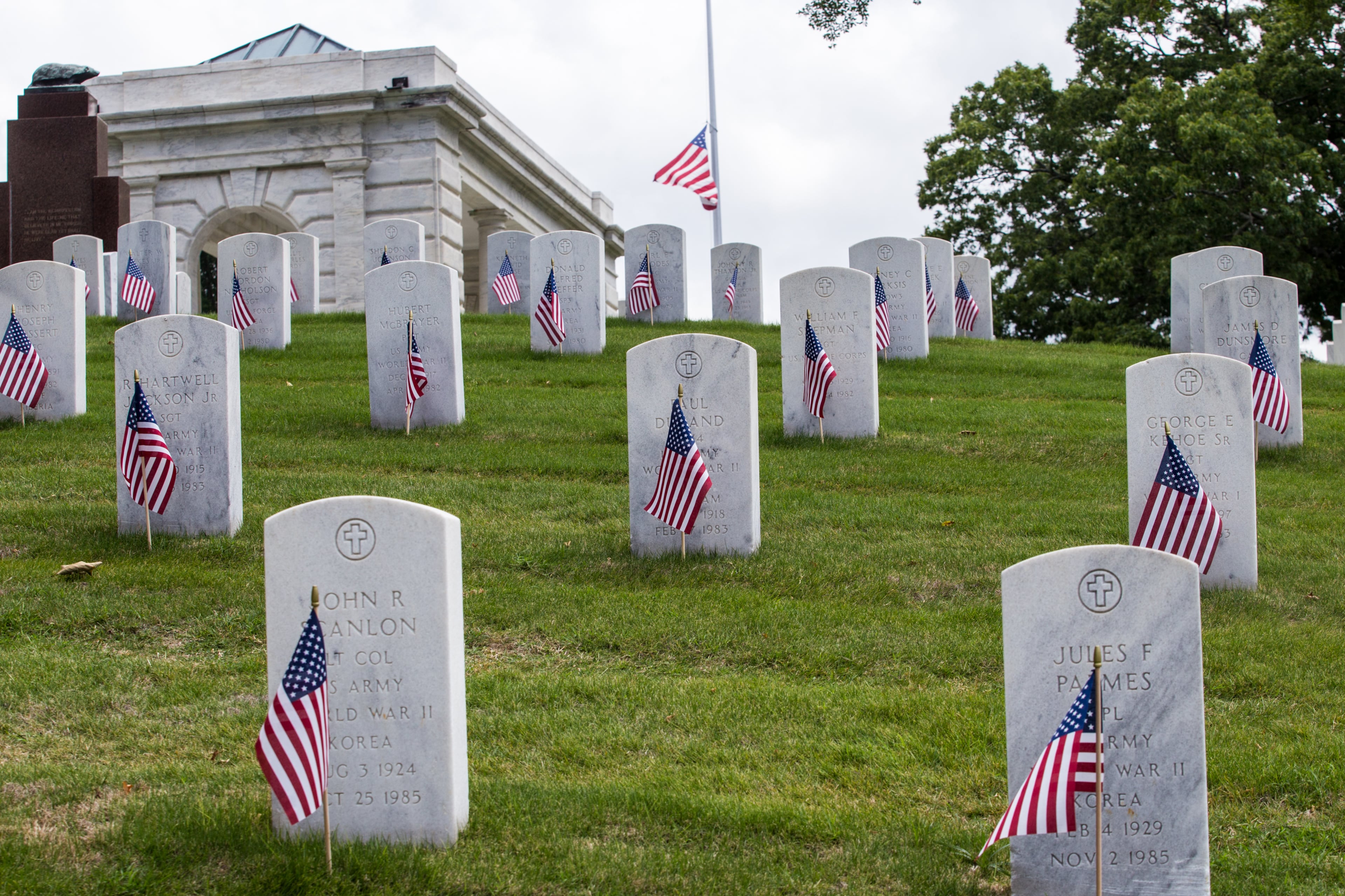 The Marietta National Cemetery did not hold official ceremonies this year, however, small groups gathered to watch the four Blackhawk helicopter flyover on Memorial Day, Monday, May 25, 2020. (Jenni Girtman for The Atlanta Journal Constitution)