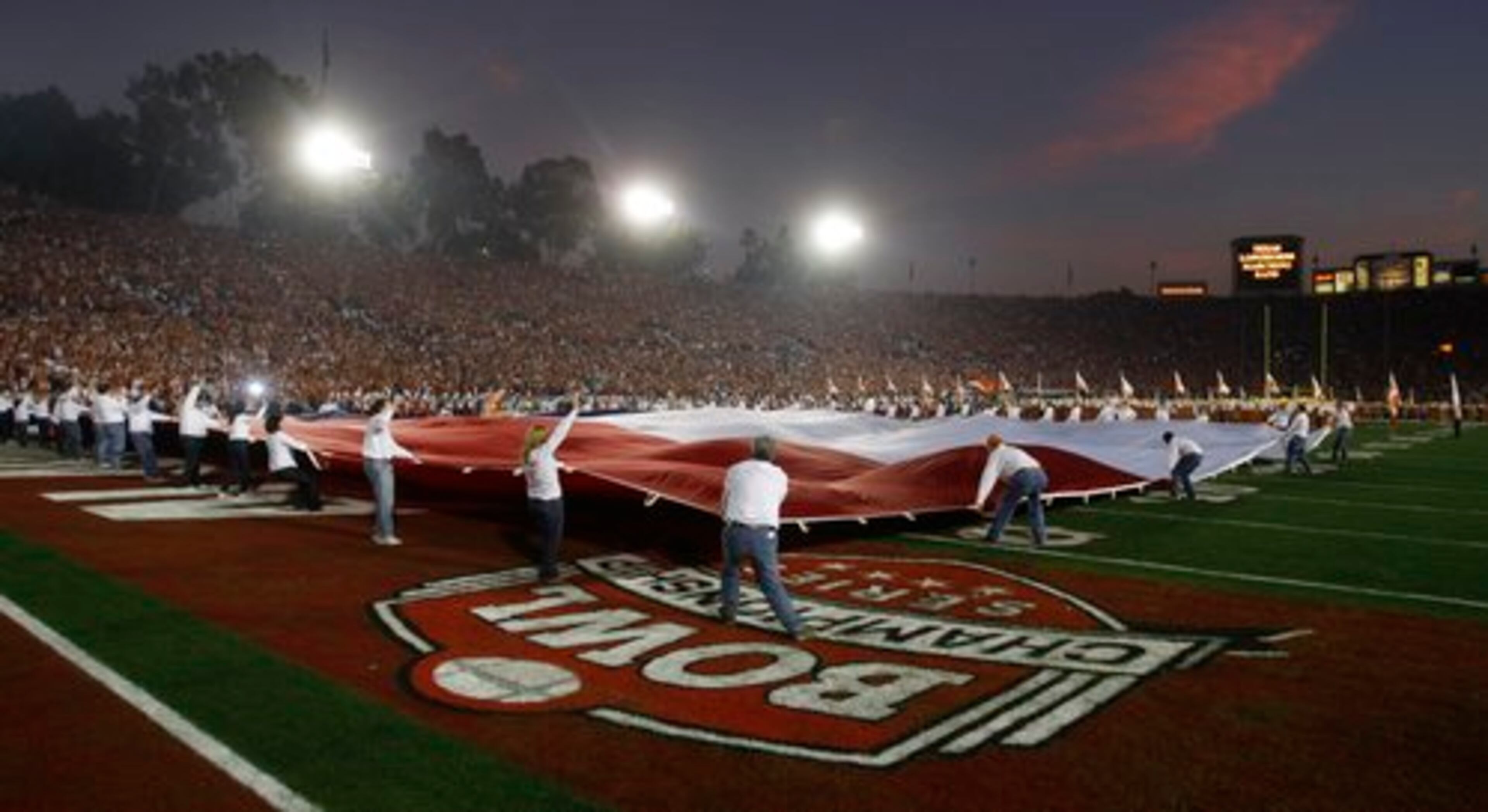 The Texas flag is unfurled over the field in the Rose Bowl.