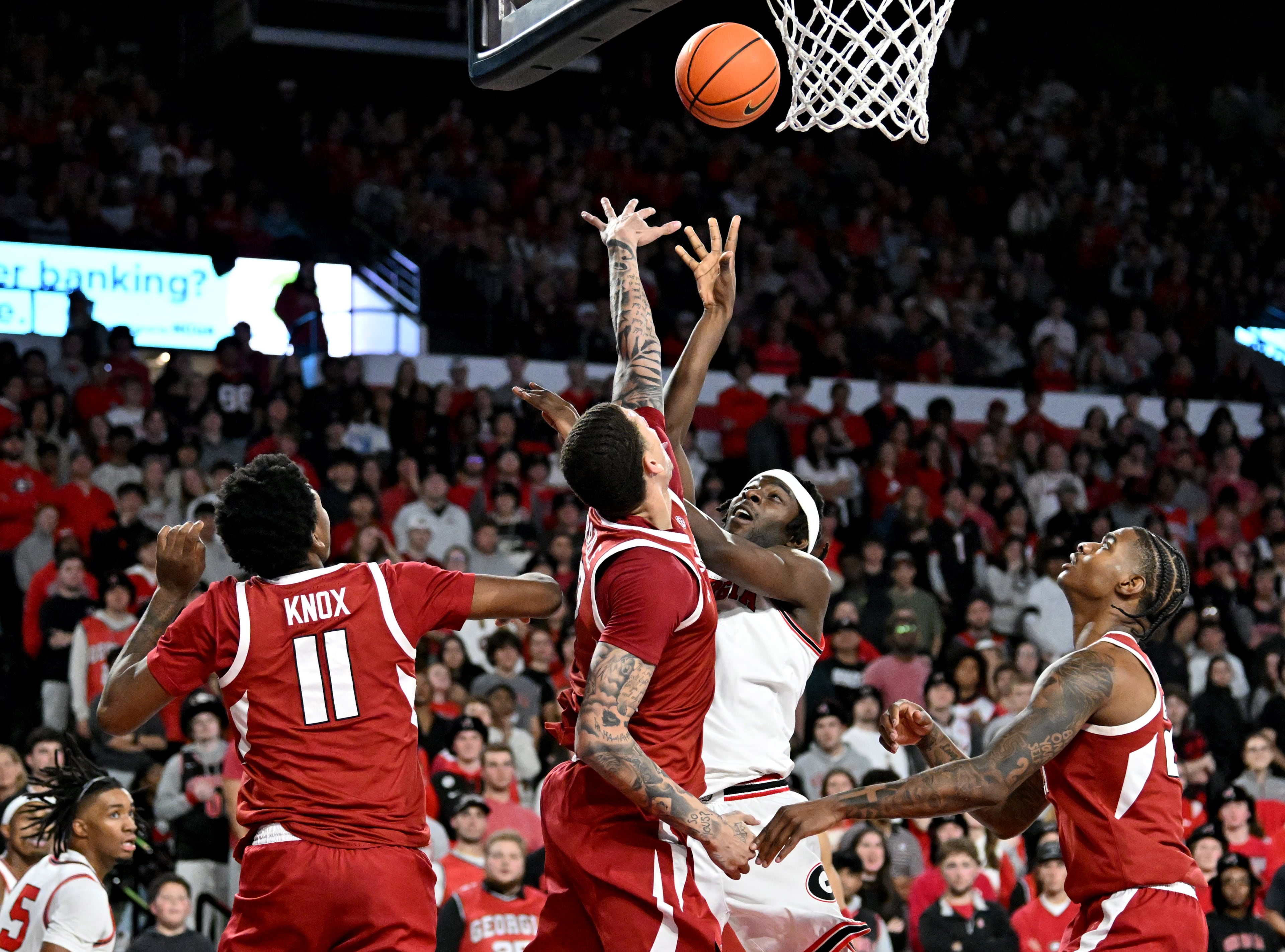 Georgia forward Dylan James (second from right) shoots against Arkansas forward Trevon Brazile (second from left) during the second half in an NCAA college basketball game at Stegeman Coliseum, Saturday, Jan. 17, 2026, in Athens. Georgia won 90-76 over Arkansas. (Hyosub Shin/AJC)