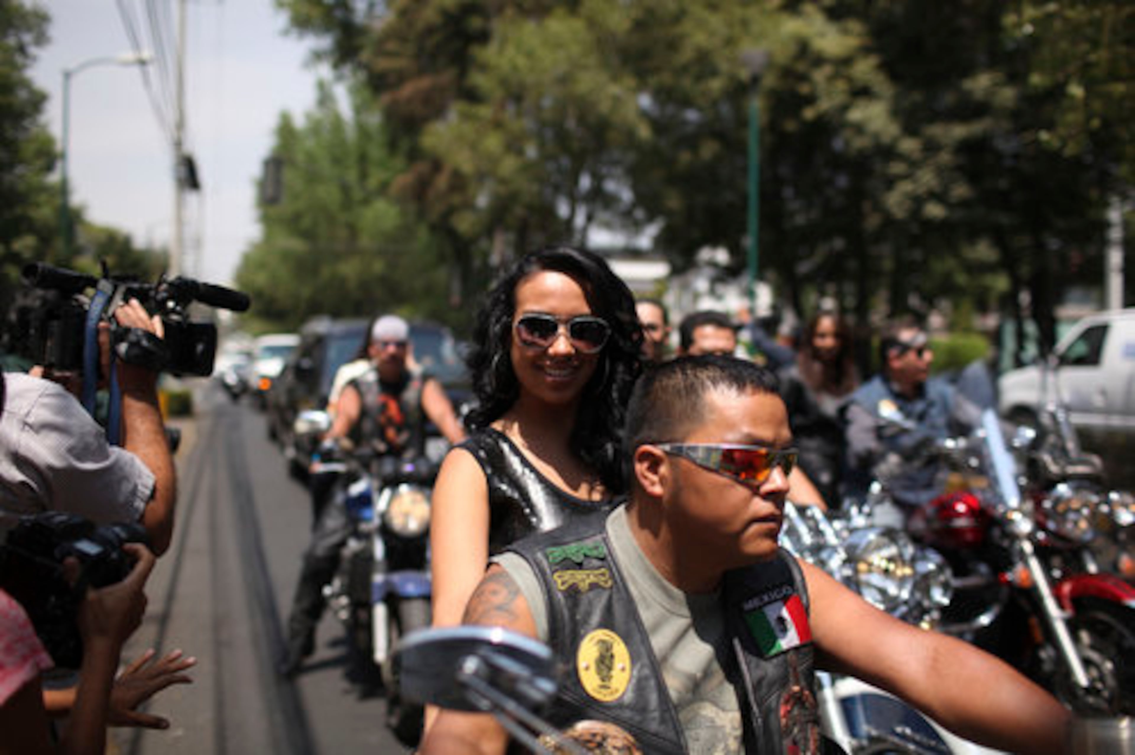A Former stewardess for Mexicana airlines, which has been in limbo since filing for bankruptcy and suspending operations last year, poses for photos on the back of a motorcycle in Mexico City, Monday April 11, 2011.