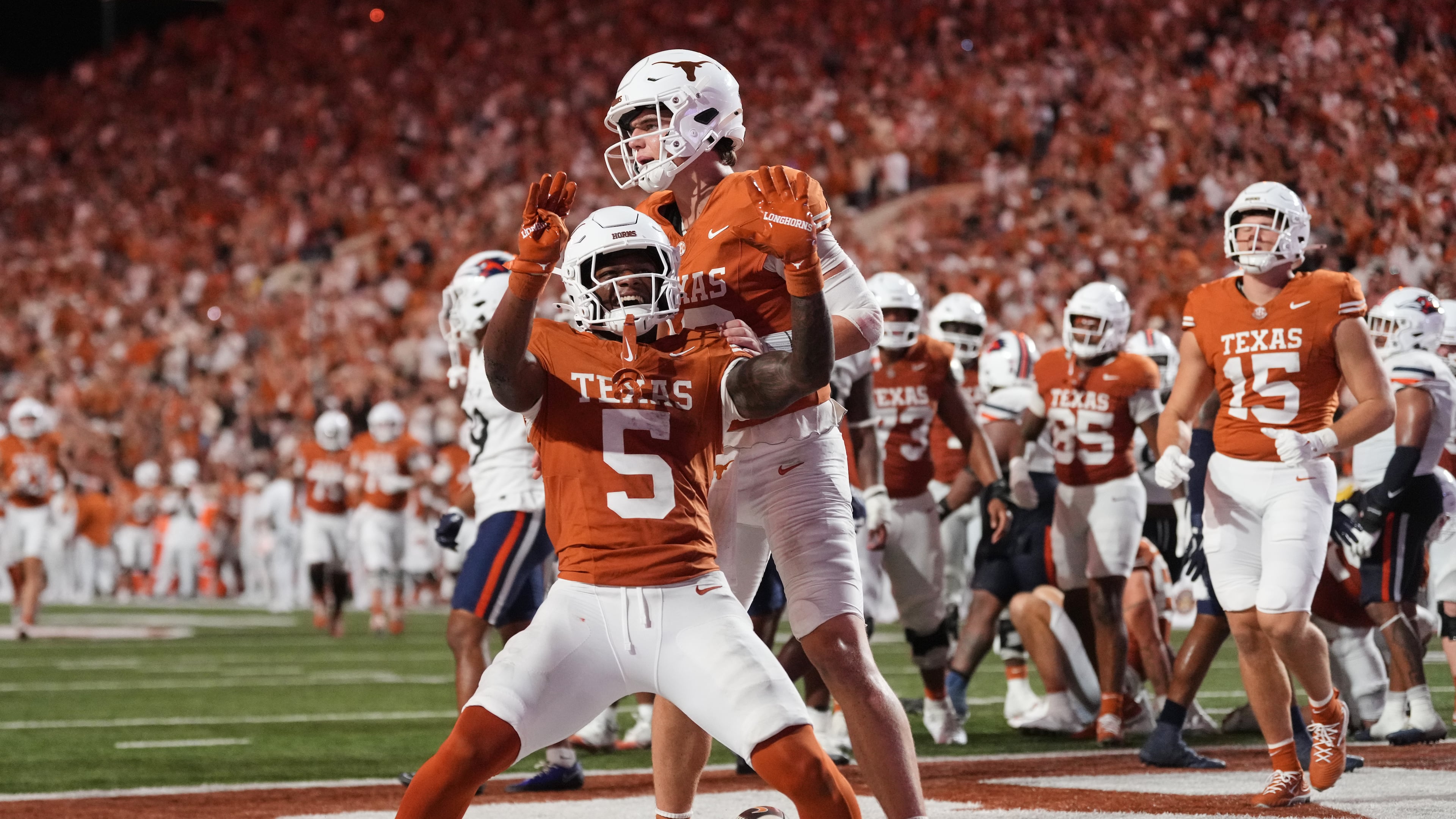 Texas running back Derrek Cooper (5) and Arch Manning, rear, celebrate after Cooper ran the ball for a touchdown during the second half of an NCAA college football game against UTSA in Austin, Texas, Saturday, Sept. 19, 2026. (AP Photo/Eric Gay)