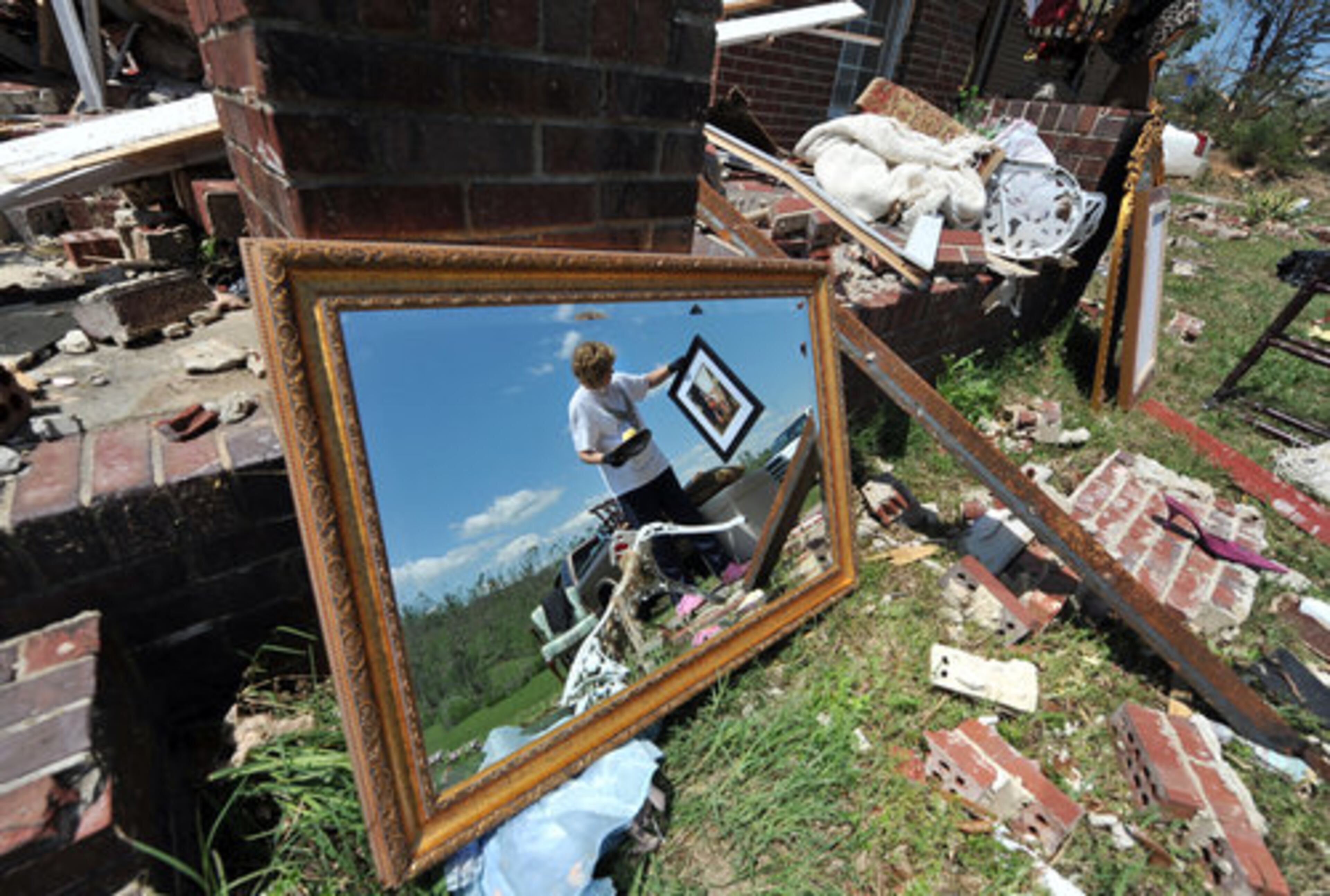 DIGGING FOR MEMORIES--Norma Parris examines a photo found the the rubble of her destroyed home Friday April 29, 2011 in Ringgold, GA. A tornado ripped through the small North Georgia community Wednesday evening, killing several nearby residents.