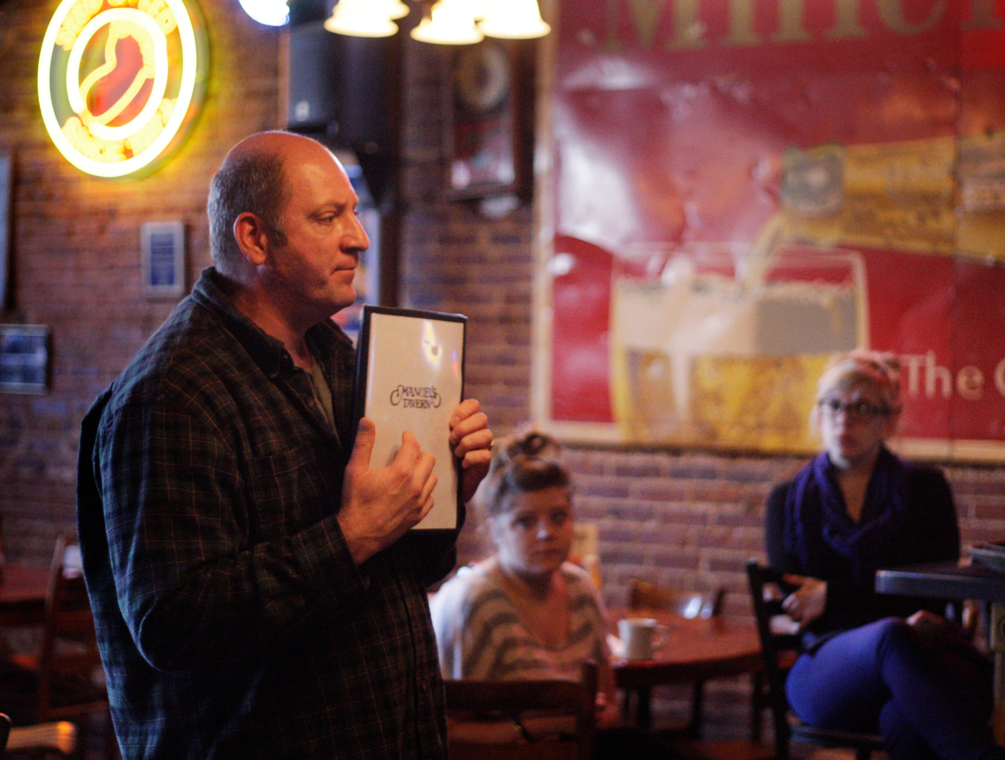 Manuel's owner Brian Maloof (left) explains how to handle the menu changes during a staff meeting in 2020. (Bob Andres/AJC)