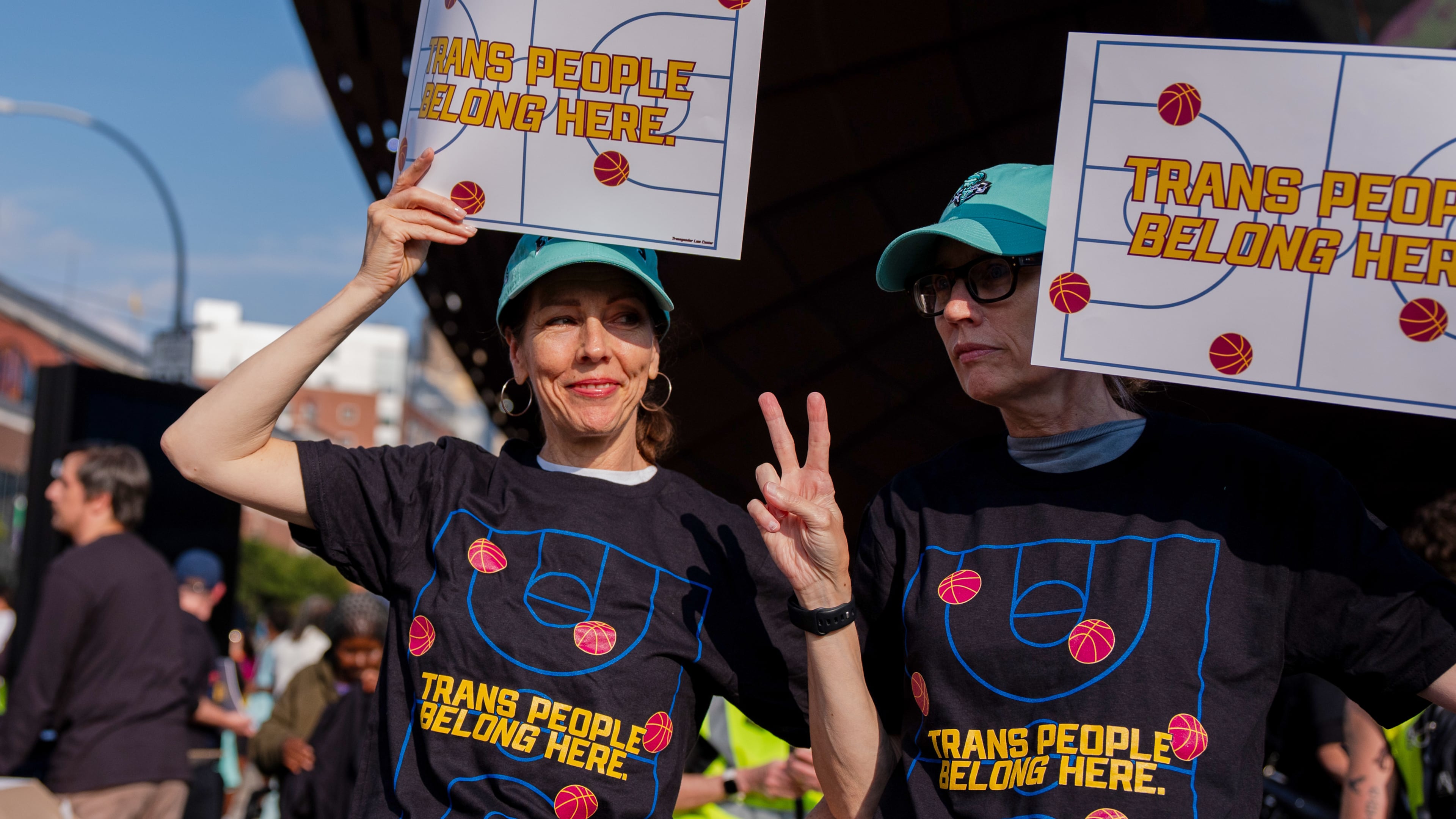 FILE - Demonstrators rally in support of transgender athletes in women's sports outside of Barclay's Center before the WNBA basketball game between the Indiana Fever and the New York Liberty, Aug. 22, 2026, in New York. (AP Photo/Angelina Katsanis, File)