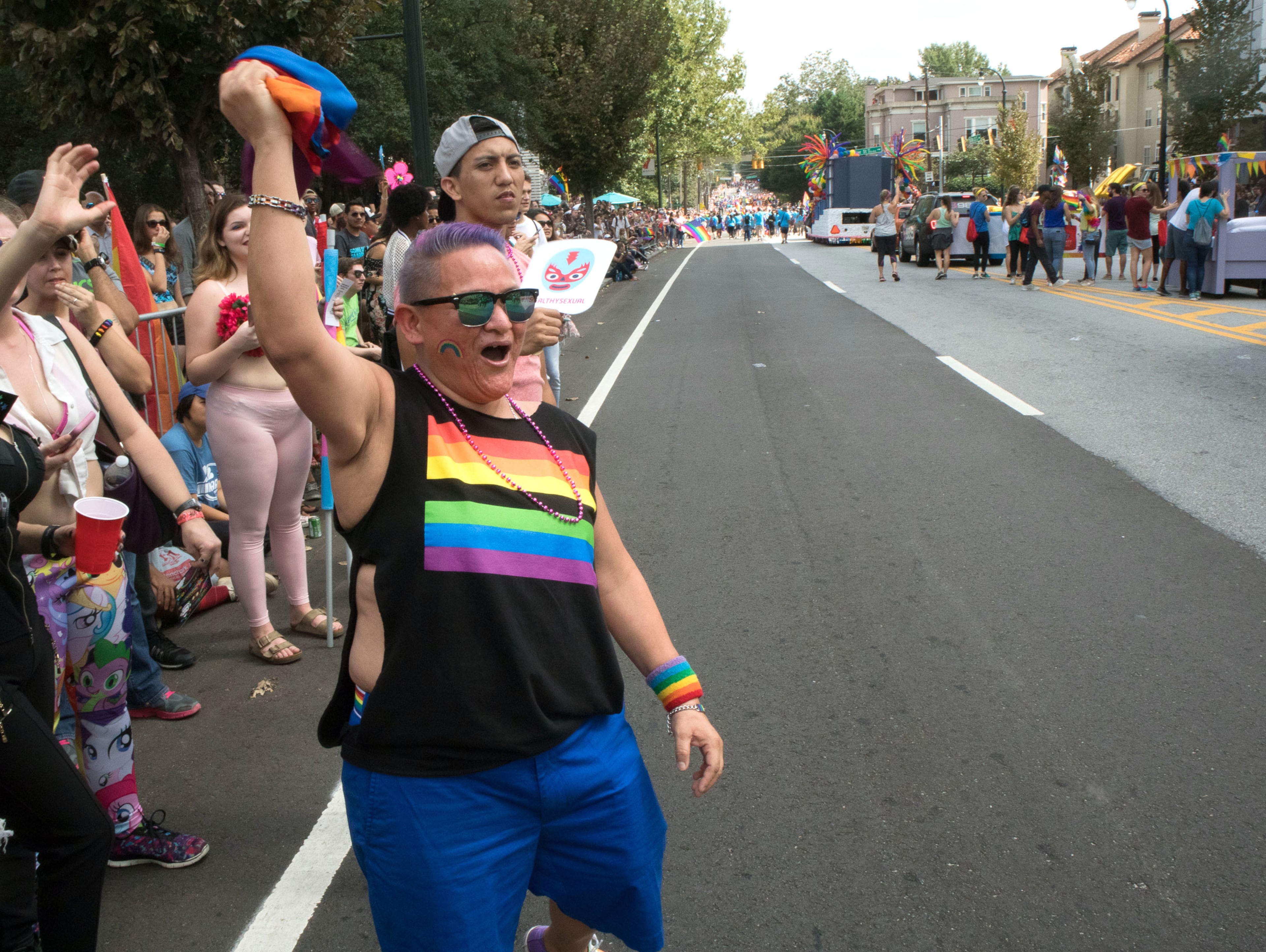Cecilia Martinez cheers as the Atlanta Pride Parade heads down 10th street toward Piedmont Park Sunday, October 15, 2017. STEVE SCHAEFER / SPECIAL TO THE AJC