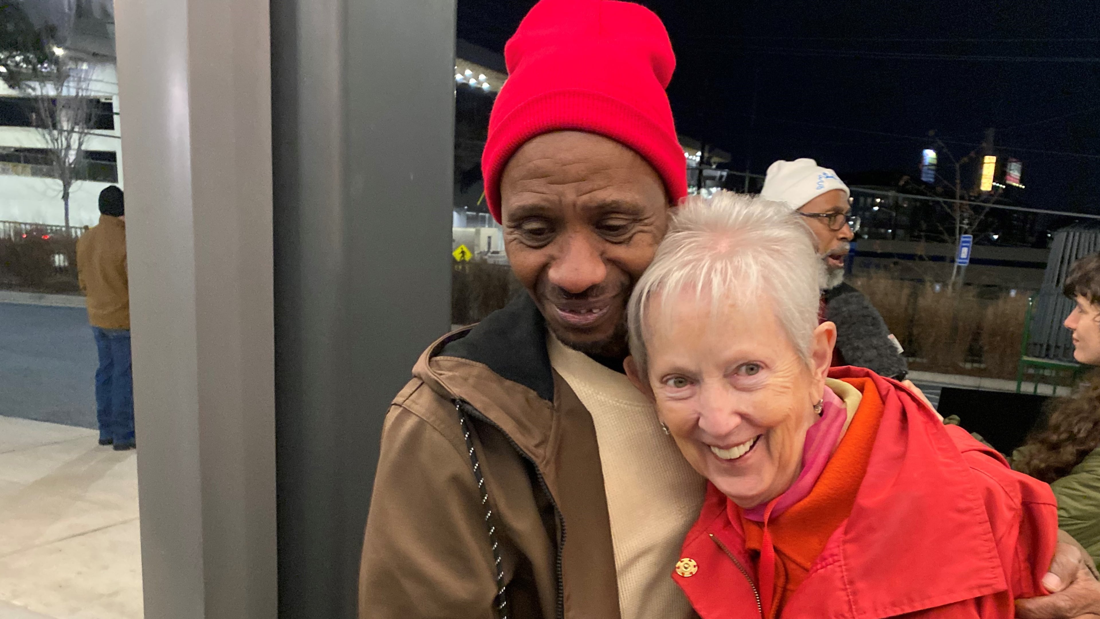 Chioke Perry, member of the Client Advisory Board to St. Joseph's Mercy Care, hugs Sister Jane Gerety, St. Joseph's Mercy Care chief mission officer, following a candlelight vigil at Mercy Care in Atlanta for 176 homeless people who died in 2024. (Ariel Hart/AJC)
