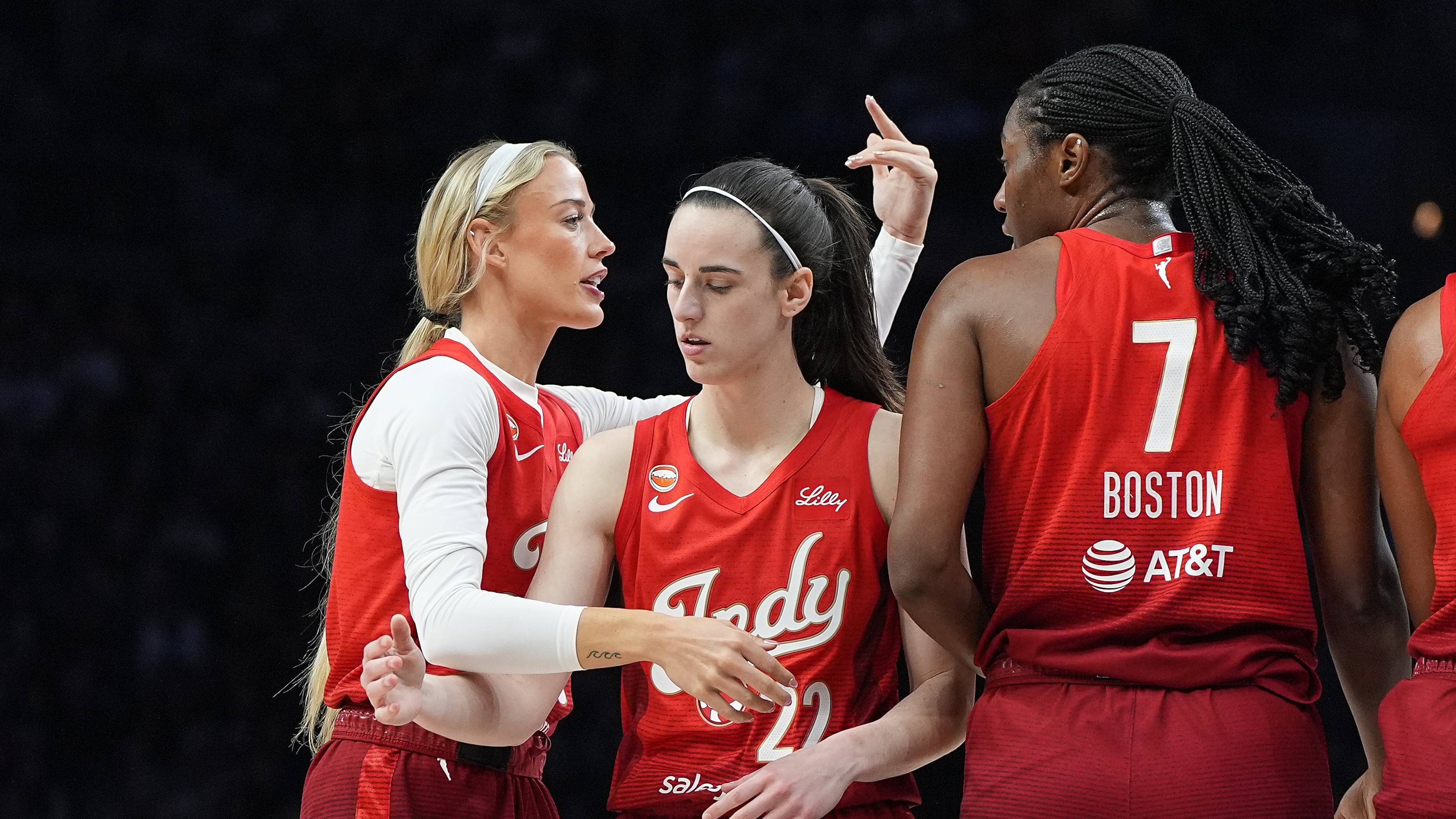 Indiana Fever guards Sophie Cunningham, left, Caitlin Clark (22) and center Aliyah Boston (7) stand on the court during the first half of a WNBA basketball game against the Minnesota Lynx, Sunday, Aug. 2, 2026, in Minneapolis. (AP Photo/Abbie Parr)