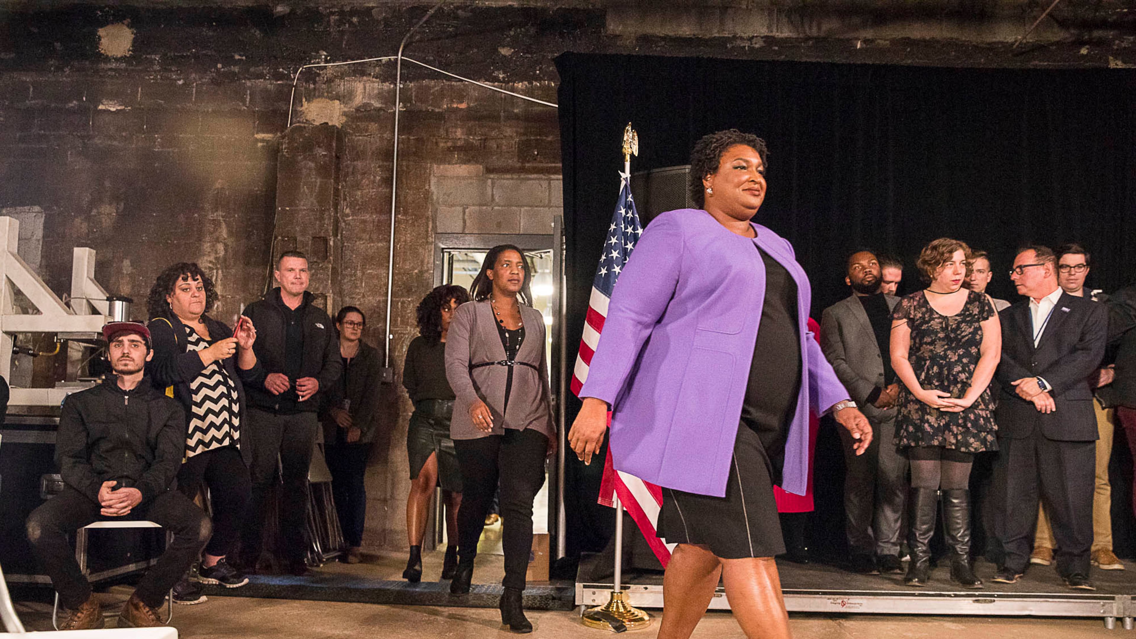 Democratic candidate for governer Stacey Abrams enters a room prepared to end her campaign during a press conference in Atlanta on Friday. ALYSSA POINTER/ALYSSA.POINTER@AJC.COM