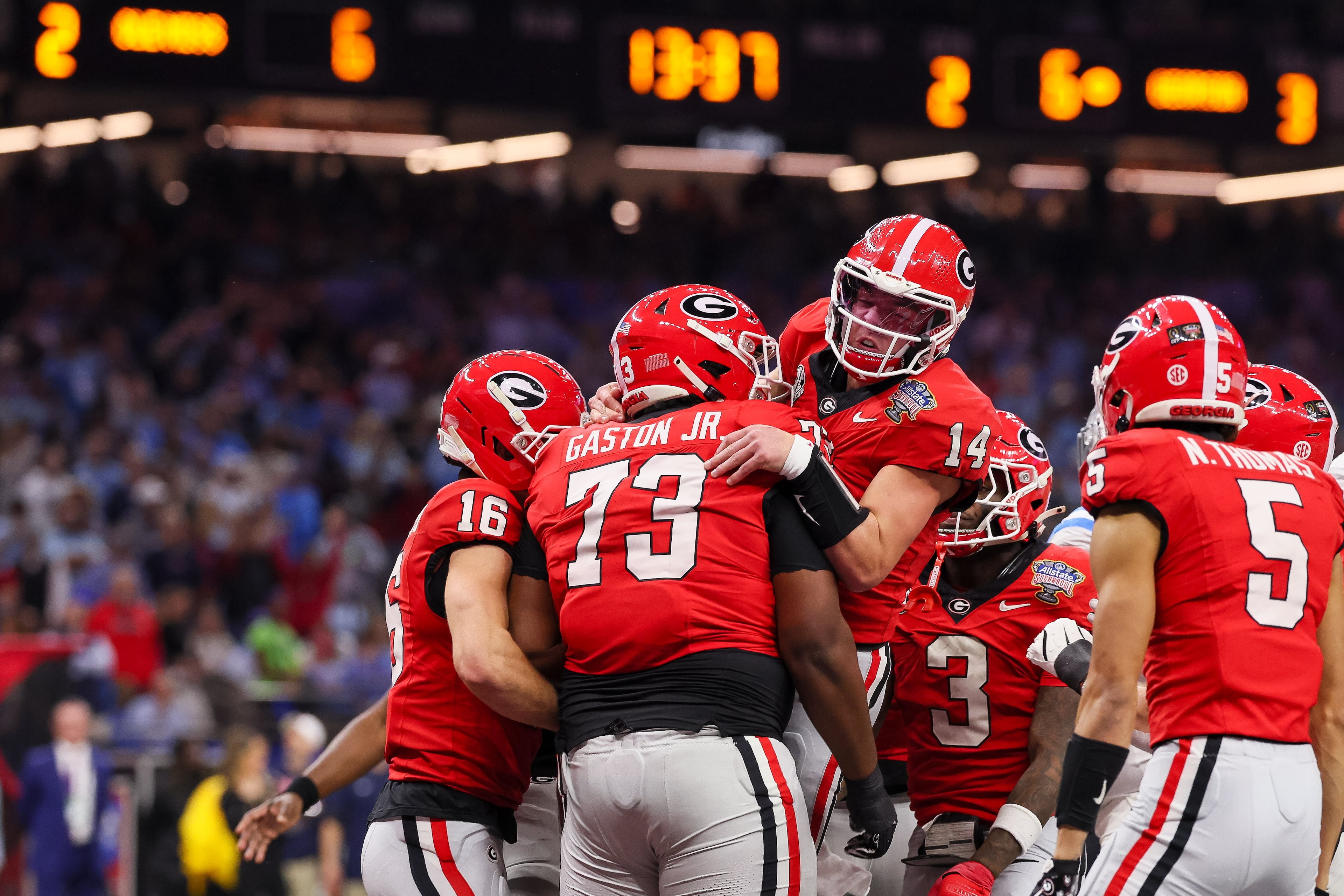 Georgia Bulldogs quarterback Gunner Stockton (14) celebrates a 12 yard touchdown run against the Ole Miss Rebels during the second quarter of the NCAA College Football Playoff quarterfinal game at the Sugar Bowl in the Caesars Superdome, Thursday, Jan. 1, 2026, in New Orleans. (Jason Getz/AJC)