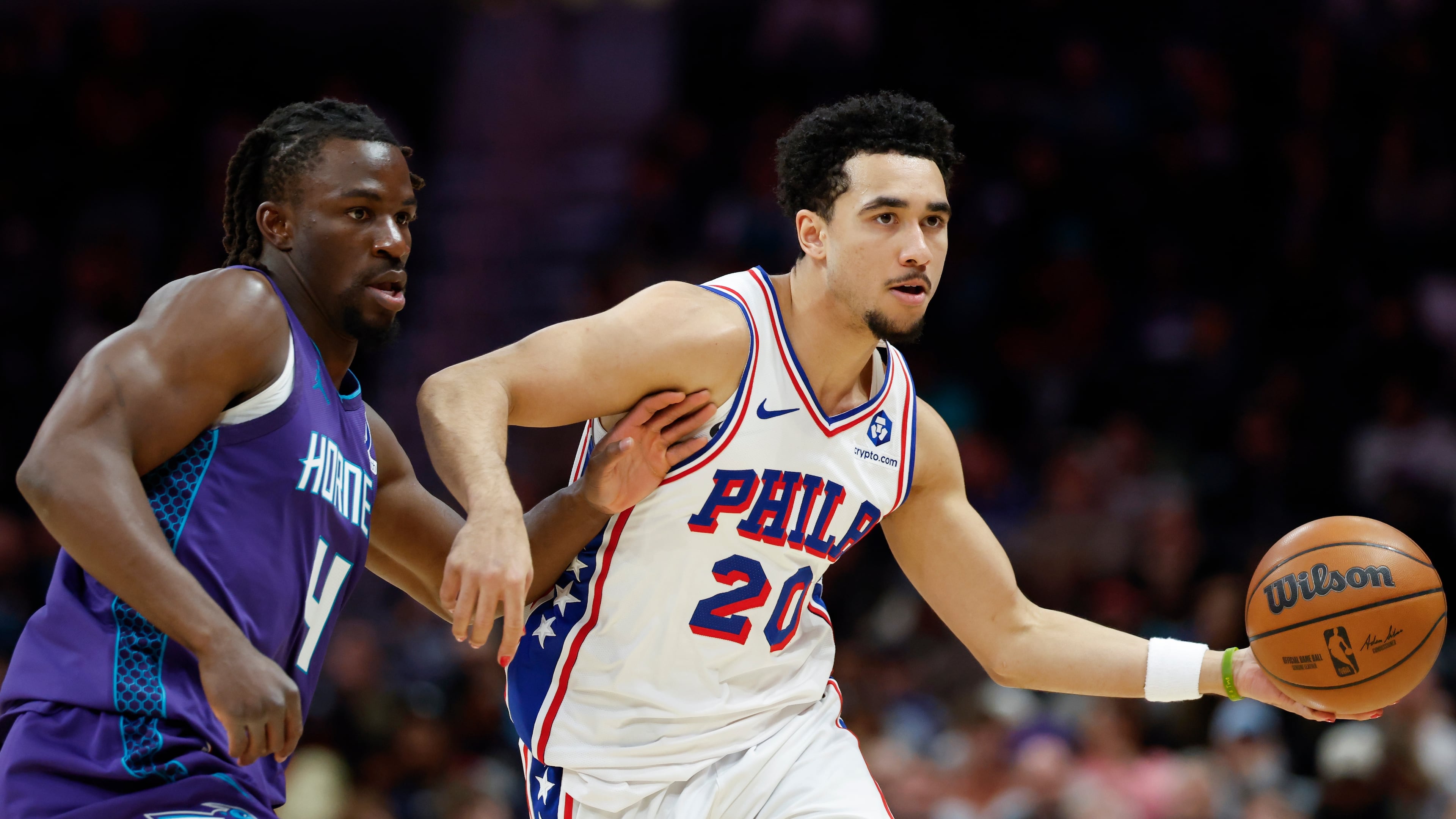 Philadelphia 76ers guard Jared McCain (20) moves the ball as Charlotte Hornets guard Sion James defends during the second half of an NBA basketball game in Charlotte, N.C., Monday, Jan. 26, 2026. (AP Photo/Nell Redmond)