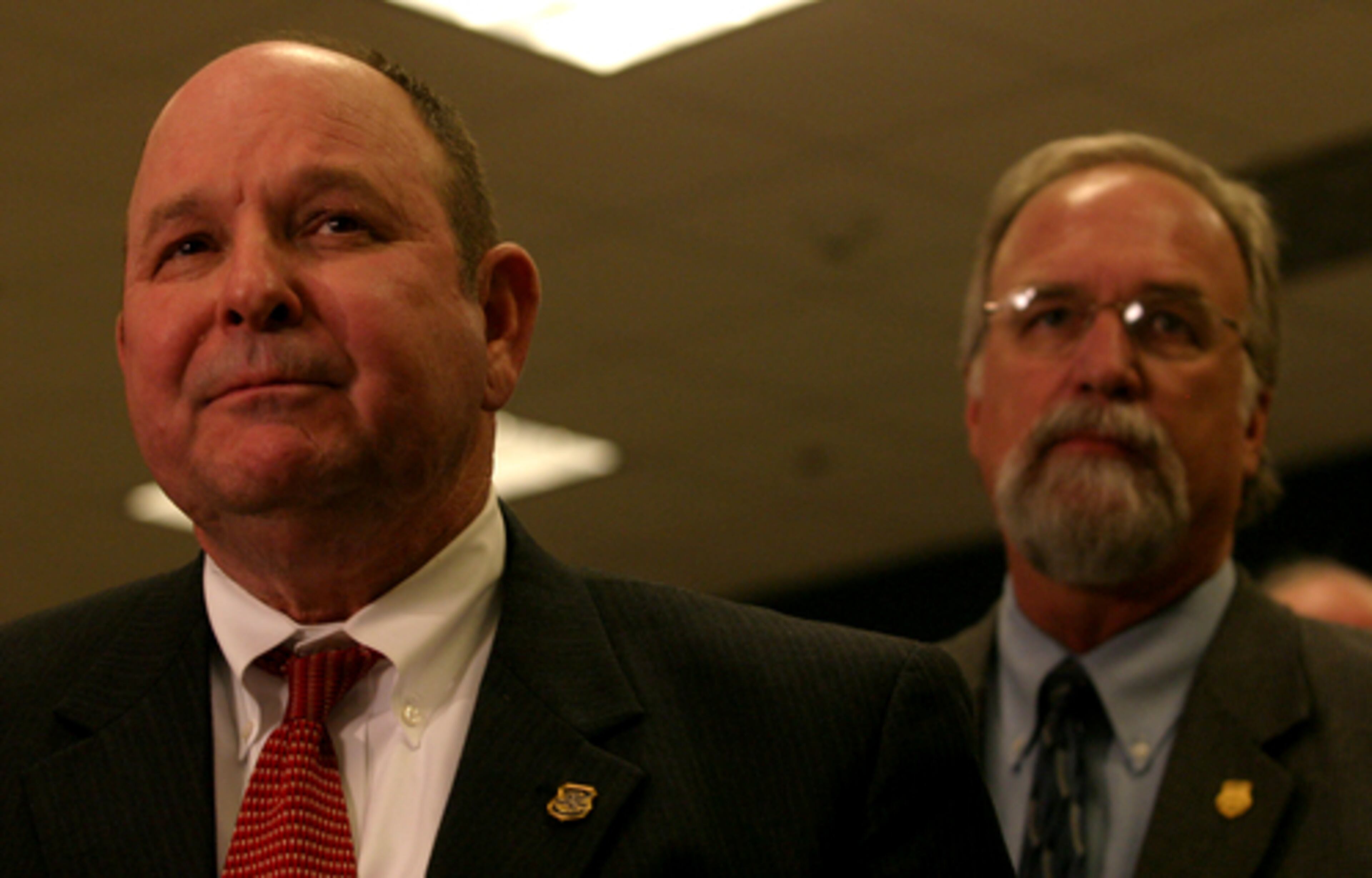 GBI director Vernon Keenan (left) and GBI Special Agent in Charge John Cagle talk Monday night in Dawsonville about the discovery of Meredith Emerson's body.