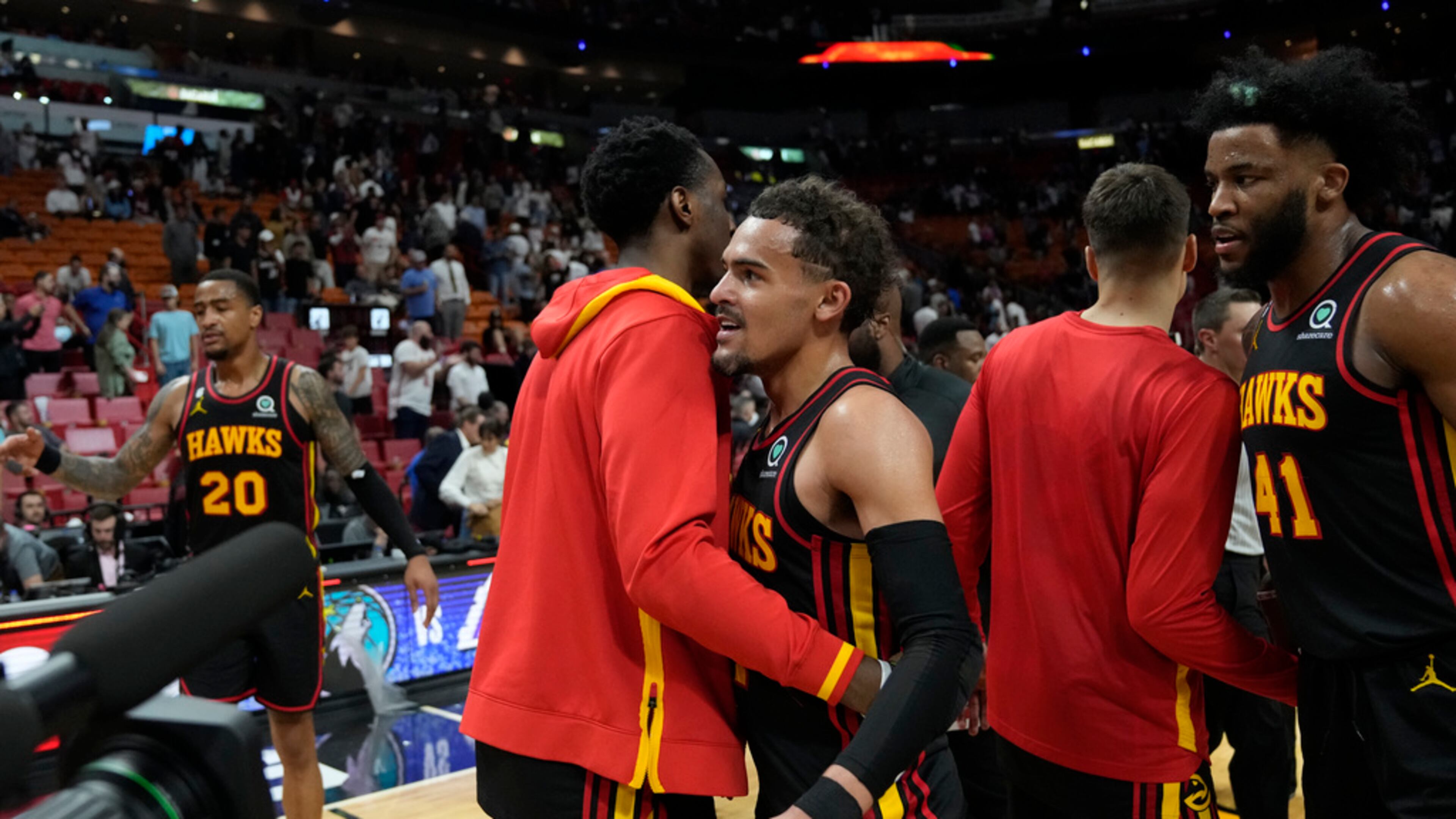 Hawks guard Trae Young, center left, and forward Saddiq Bey (41) celebrate with teammates after the Hawks defeated the Miami Heat in an NBA basketball play-in tournament game Tuesday, April 11, 2023, in Miami. (AP Photo/Rebecca Blackwell)