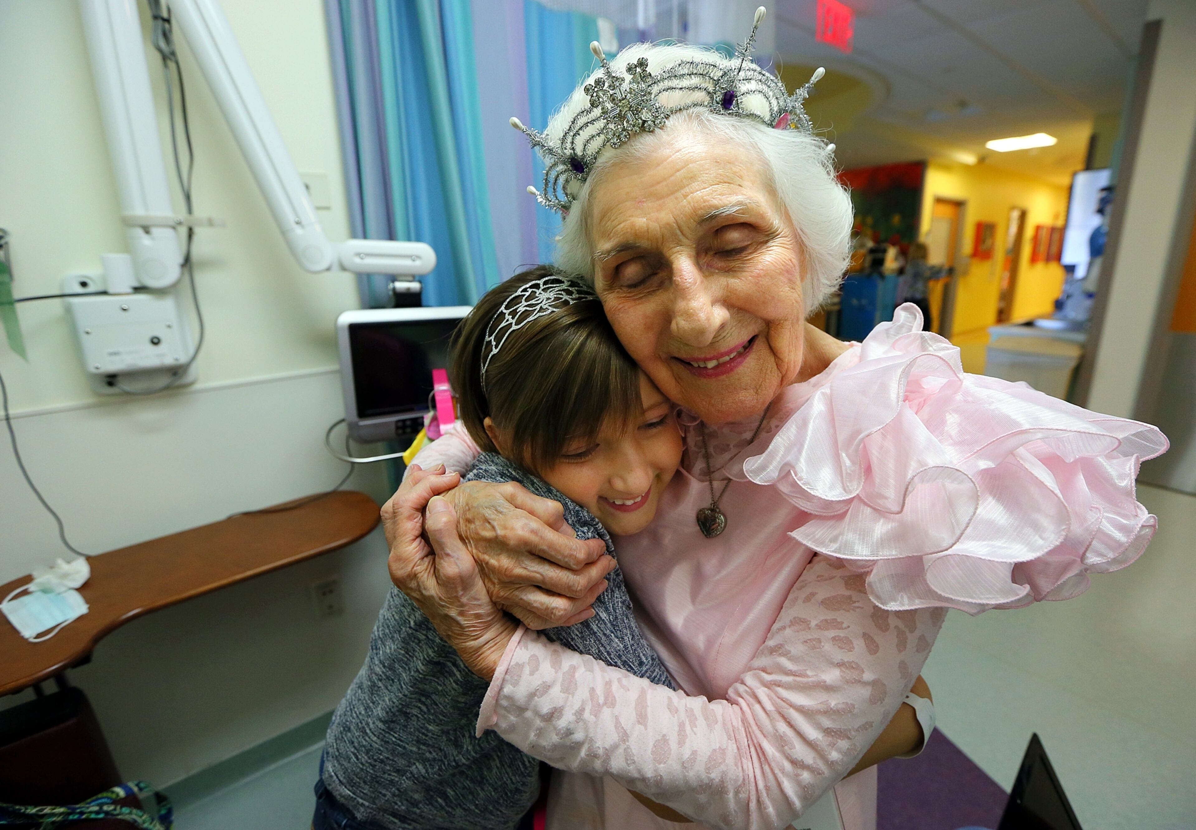 AJC photographer Curtis Compton spent a month roaming the corridors of Children’s Healthcare of Atlanta at Egleston to capture the joy Jackie Viener brings children suffering from serious disease. Here, “world’s best hugger” Viener ends a visit with 13-year-old Hannah Layfield by bestowing one of her trademark embraces before the girl’s last chemotherapy treatment.
