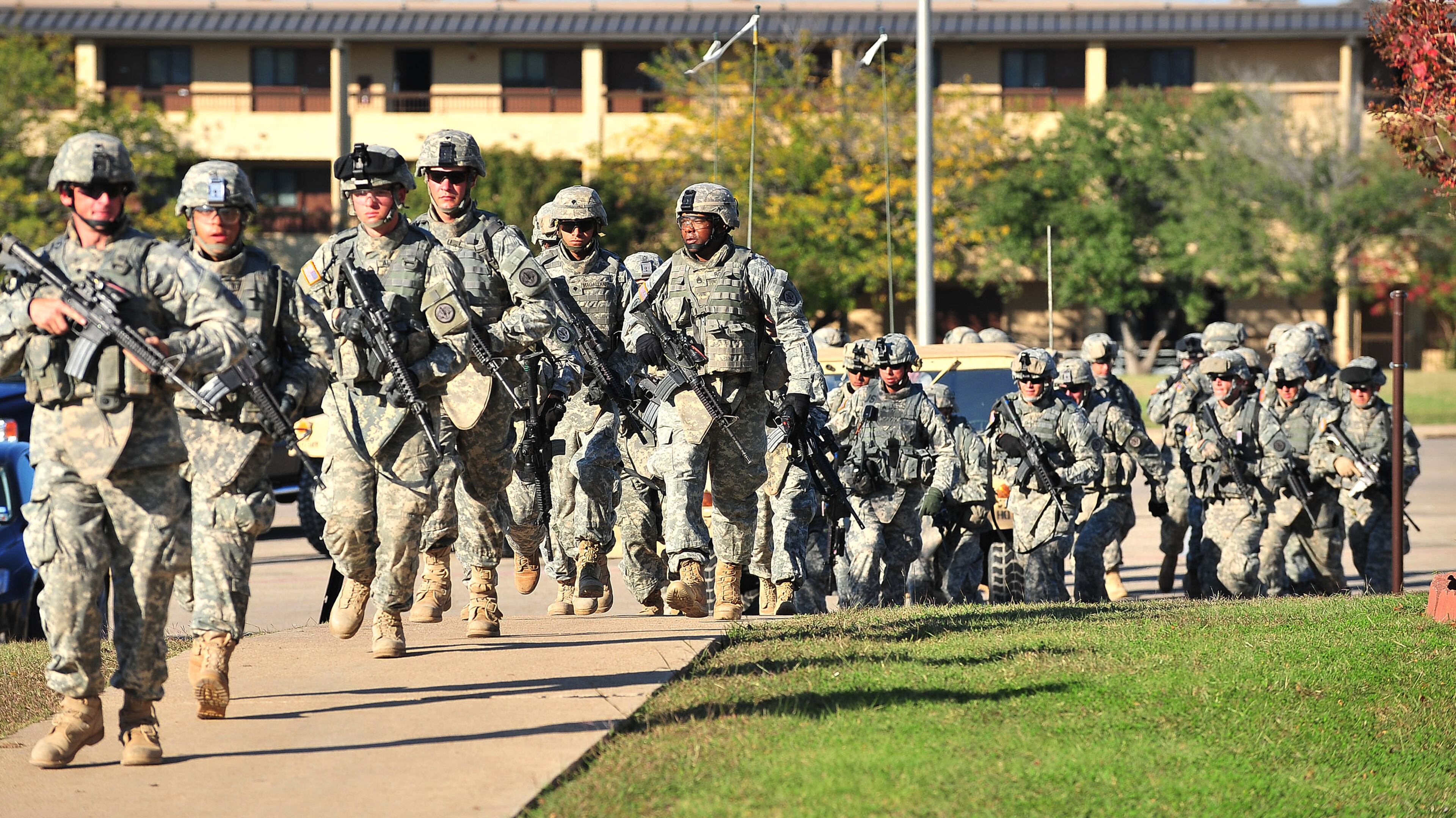 FILE - Soldiers from the 3rd Armored Cavalry Regiment storm the grounds of the Soldier Readiness Center to apprehend a mass shooter in Fort Hood, Texas, on Nov. 5, 2009. (David Morris/Killeen Daily Herald via AP, File)