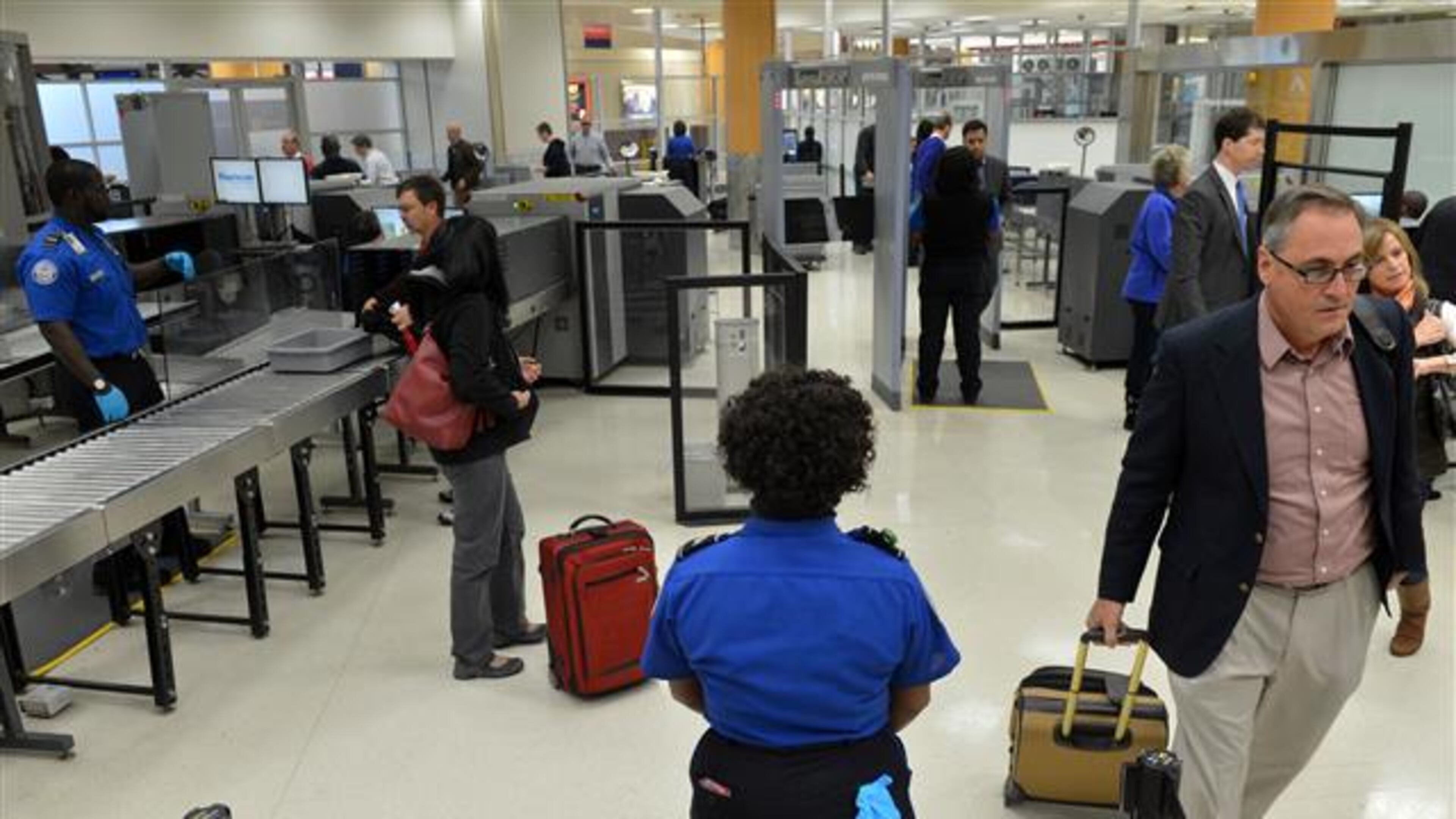JANUARY 15, 2014 ATLANTA TSA agents man the checkpoint for pre-cleared passengers Wednesday. The Transportation Security Administration (TSA) officially opened an application site at Hartsfield-Jackson Atlanta International Airport (ATL) Wednesday, January 15, 2014, for TSA Pre (TM), an expedited screening program that allows travelers to leave on their shoes, light outerwear and belt, keep their laptop in its case and keep 3-1-1 compliant liquids/gels bag in a carry-on bag. U.S. citizens and lawful permanent residents will now be able to go through a pre-enrollment process online at www.TSA.gov, make an appointment and complete their enrollment at the application center at gate A19 to verify their identity and provide documentation to confirm their citizenship/immigration status as well as to provide fingerprints. TSA is currently in the process of expanding to more than 300 application centers across the country. The application center at Hartsfield-Jackson Atlanta International Airport is one of the first centers to open in the southeast. KENT D. JOHNSON / KDJOHNSON@AJC.COM