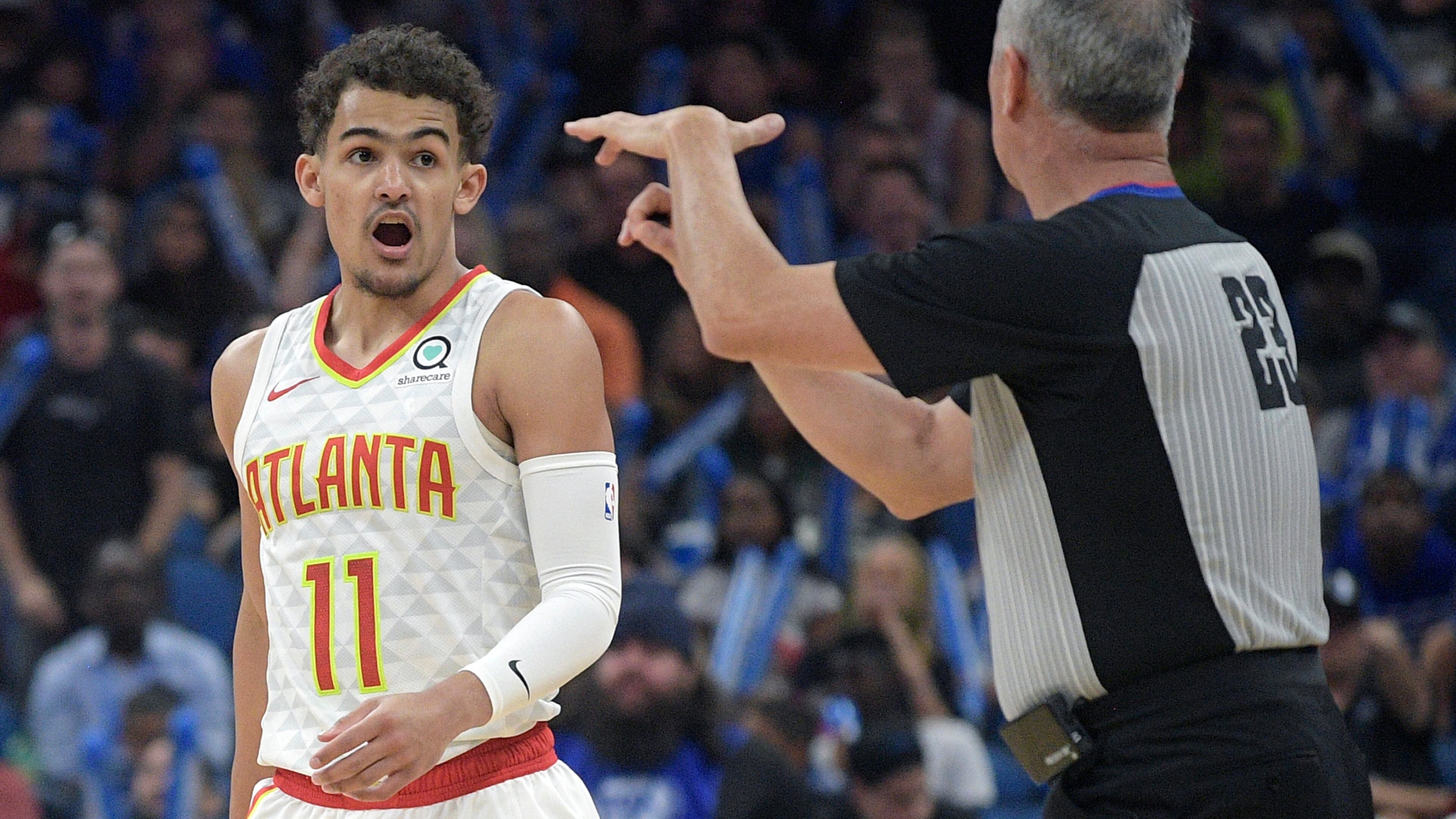 Hawks guard Trae Young (11) receives a technical foul from official Jason Phillips (23) while arguing after a score by the Orlando Magic on Friday. (AP Photo/Phelan M. Ebenhack)