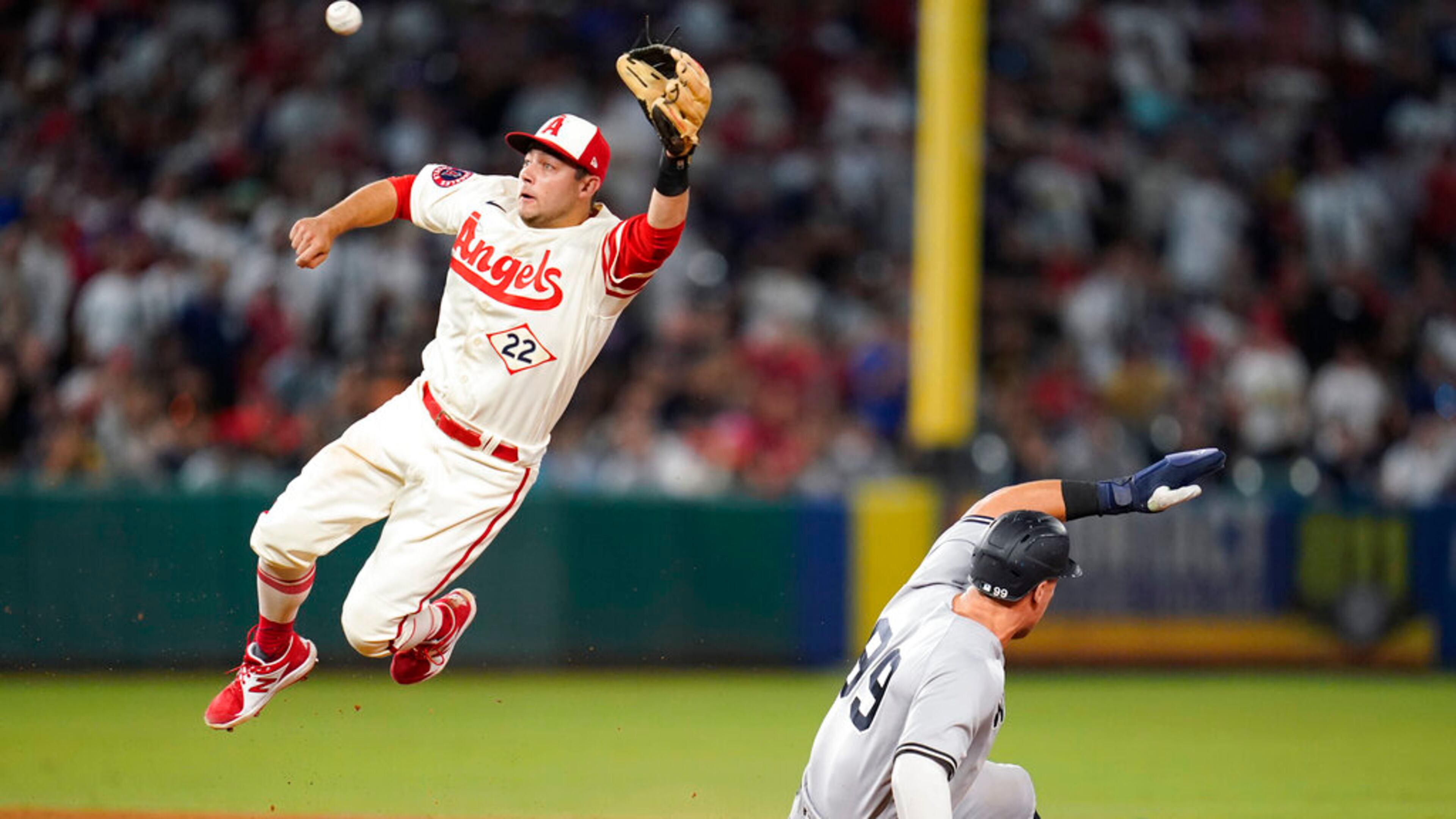 New York Yankees' Aaron Judge (99) steals second base ahead of a throw to Los Angeles Angels shortstop David Fletcher (22) during the ninth inning of a baseball game in Anaheim, Calif., Wednesday, Aug. 31, 2022. (AP Photo/Ashley Landis)
