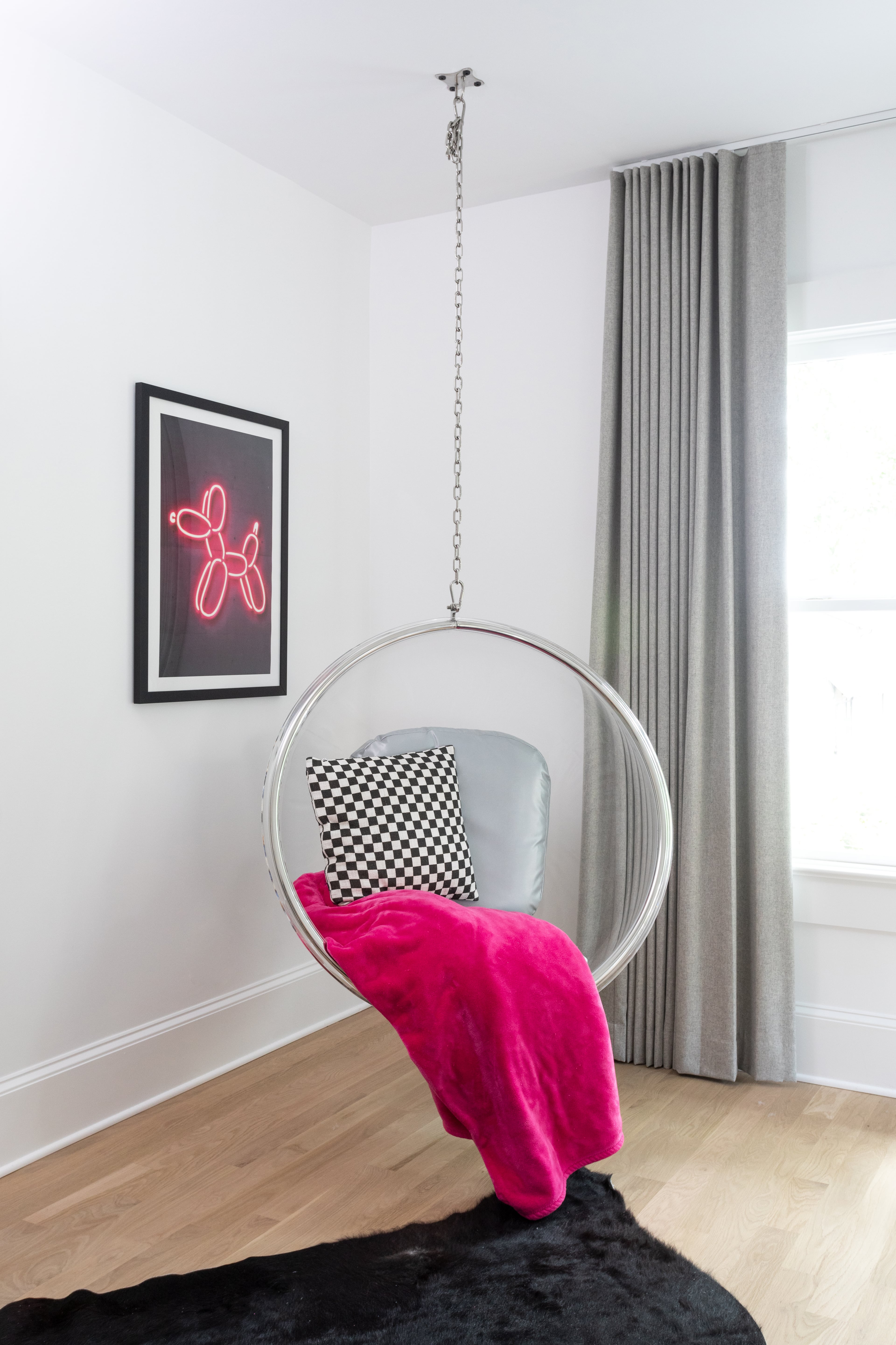A charming bubble swing from Etsy hangs from the ceiling in Brian McBrearty’s bedroom, accented by a pink throw and print by Octavian Mielu. “I love pops of color like bright pink and neon,” McBrearty said. Text by Lori Keong/Photo by Heidi Harris