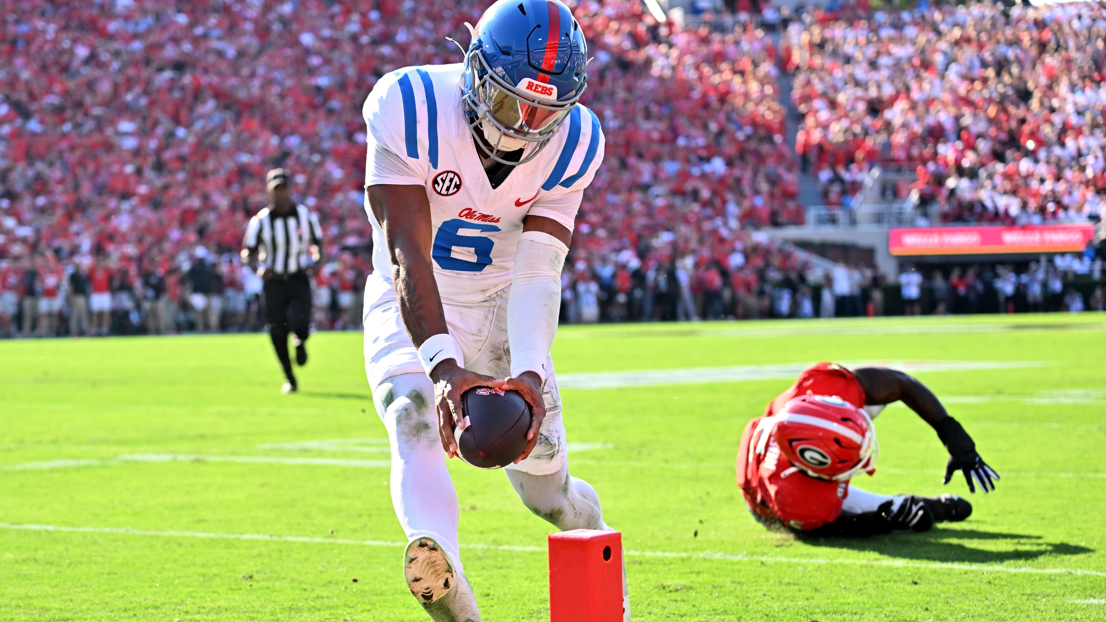 Mississippi quarterback Trinidad Chambliss runs past Georgia linebacker Raylen Wilson for a touchdown during the first half of Saturday's game at Sanford Stadium. (Hyosub Shin/AJC)
