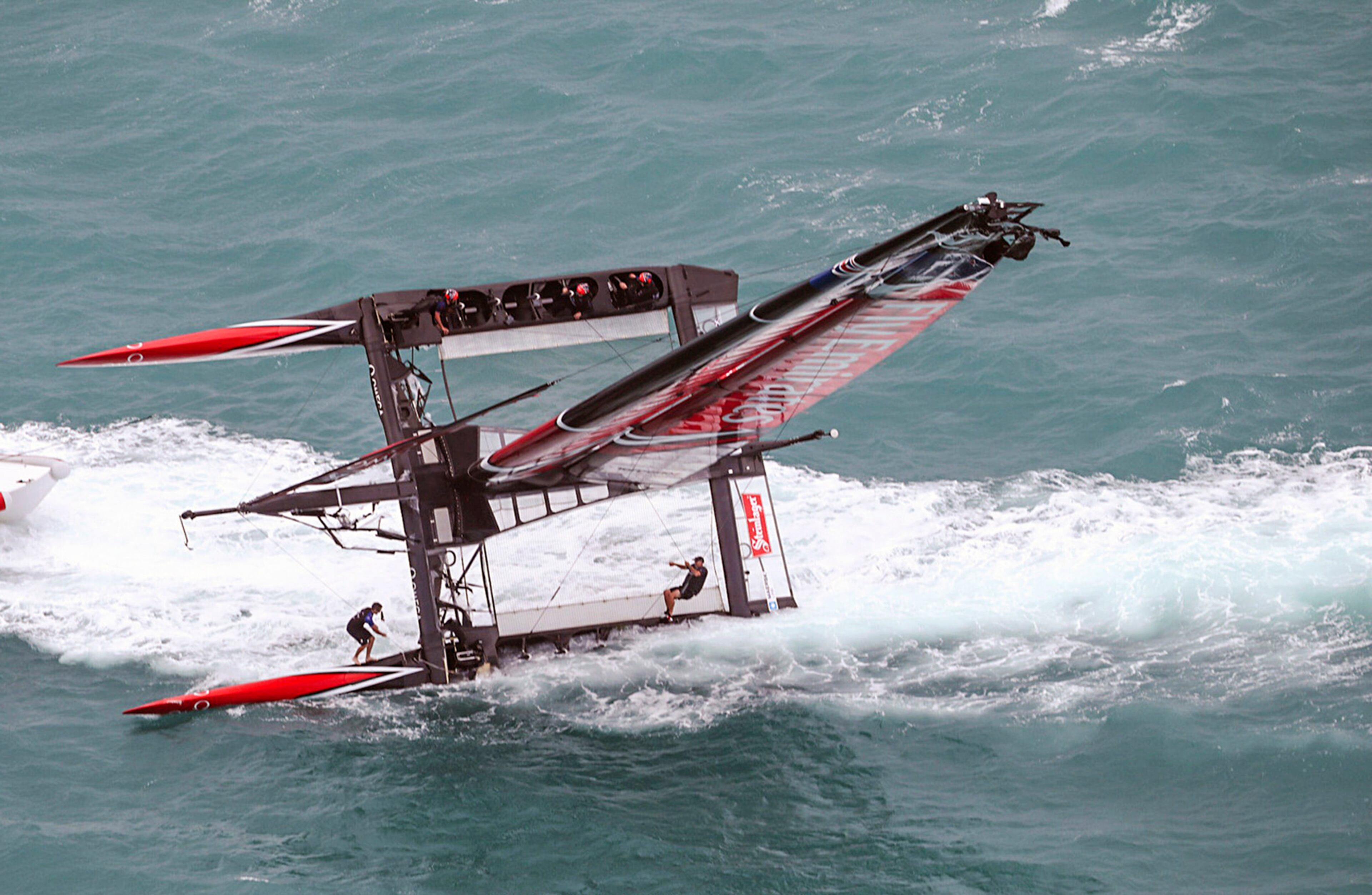In this photo provided by America's Cup Event Authority, Emirates Team New Zealand capsizes during an America's Cup challenger semifinal against Great BritainÕs Land Rover BAR on the Great Sound in Bermuda on Tuesday, June 6, 2017. (Gilles Martin-Raget/ACEA via AP)