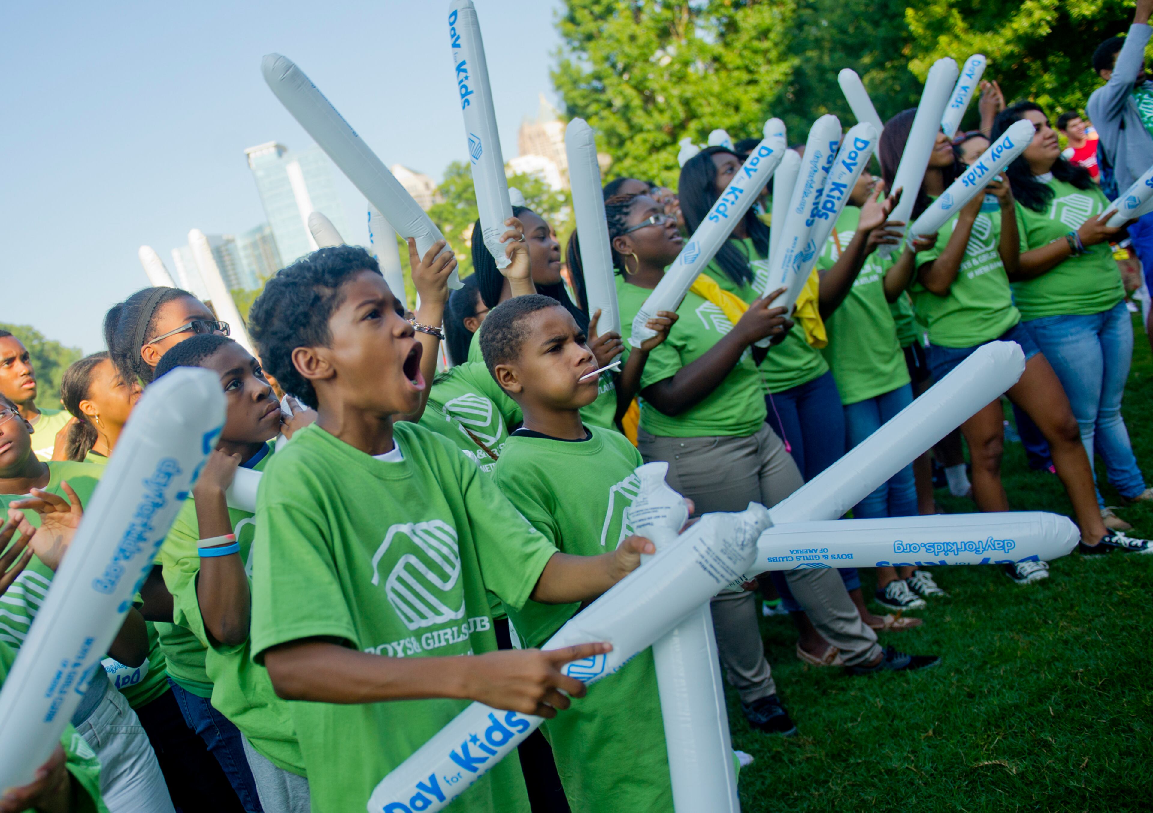 Kobe Jackson (left) and Darren Harrell cheer with hundreds of others during the Boys & Girls Clubs of America's Day for Kids at Piedmont Park in Atlanta on Saturday, September 7, 2013. Day for Kids is a national initiative to raise awareness for critical issues facing young men and women. With more than a decade of tradition, Day for Kids invites adults to act like kids again by participating in field day events such as relay races, dodge ball, tug of war and lots of other activities. JONATHAN PHILLIPS / SPECIAL