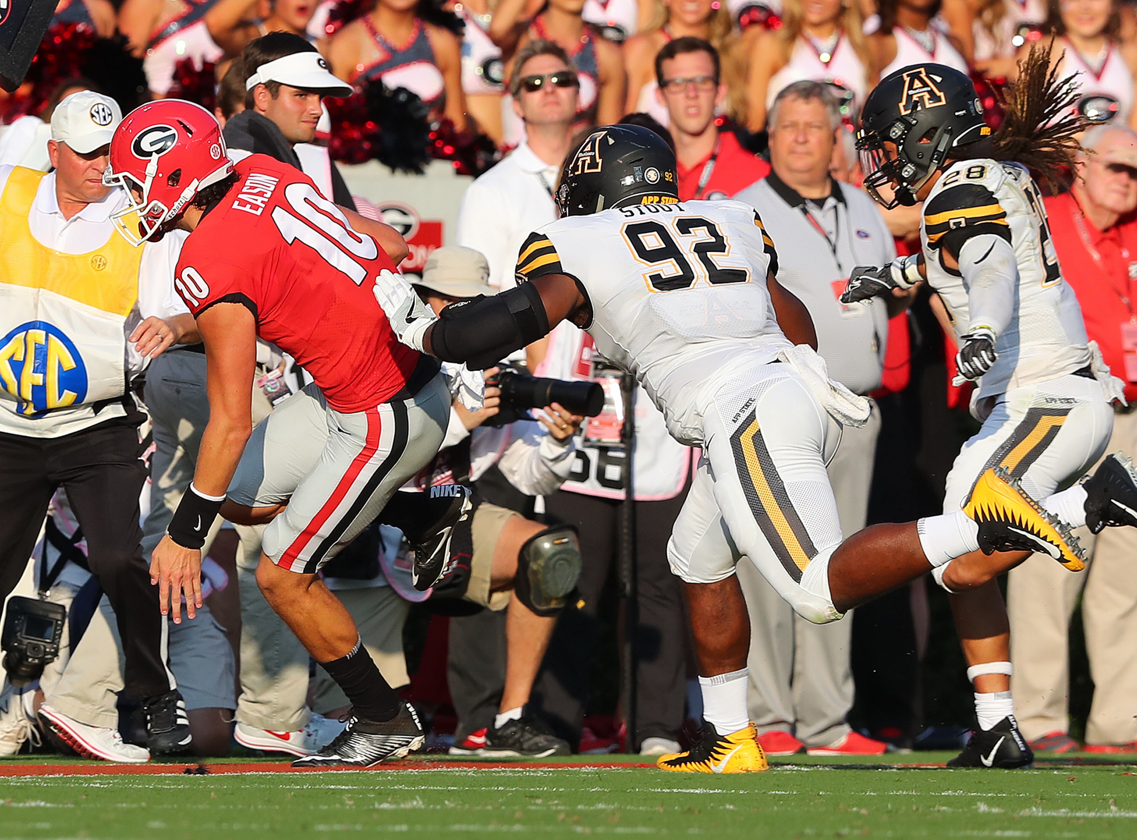 September 2, 2017 Athens: Georgia quarterback Jacob Eason is injured and leaves the game as he is pushed out of bounds by Appalachian State defender Myquon Stout who was penalized on the play during the first quarter in a NCAA college football game on Saturday, September 2, 2017, in Athens. Curtis Compton/ccompton@ajc.com