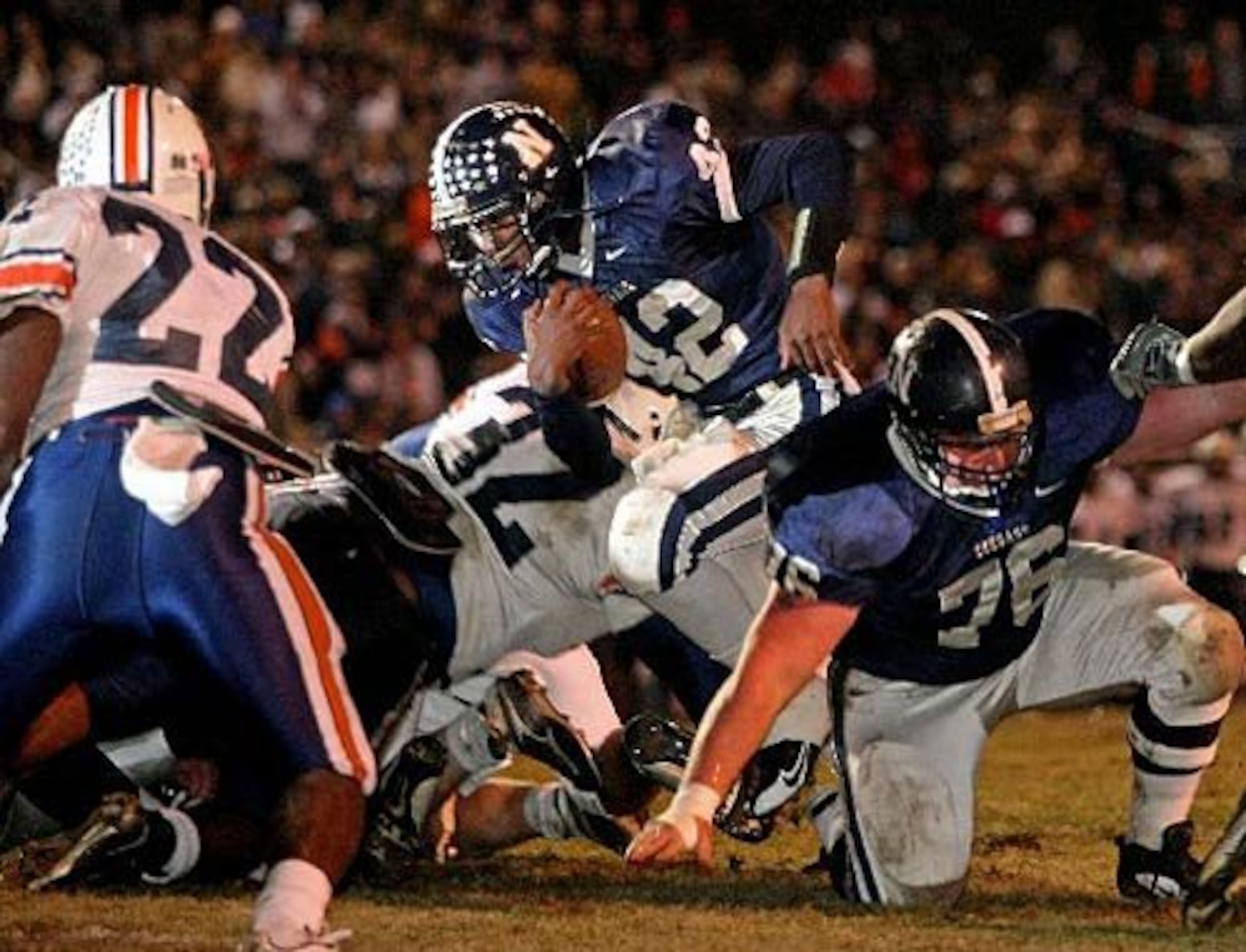 Newnan running back Bryant Ball (42, center) scores the first touchdown of the night as lineman David Rowe (76, right) blocks against the Northside defense.