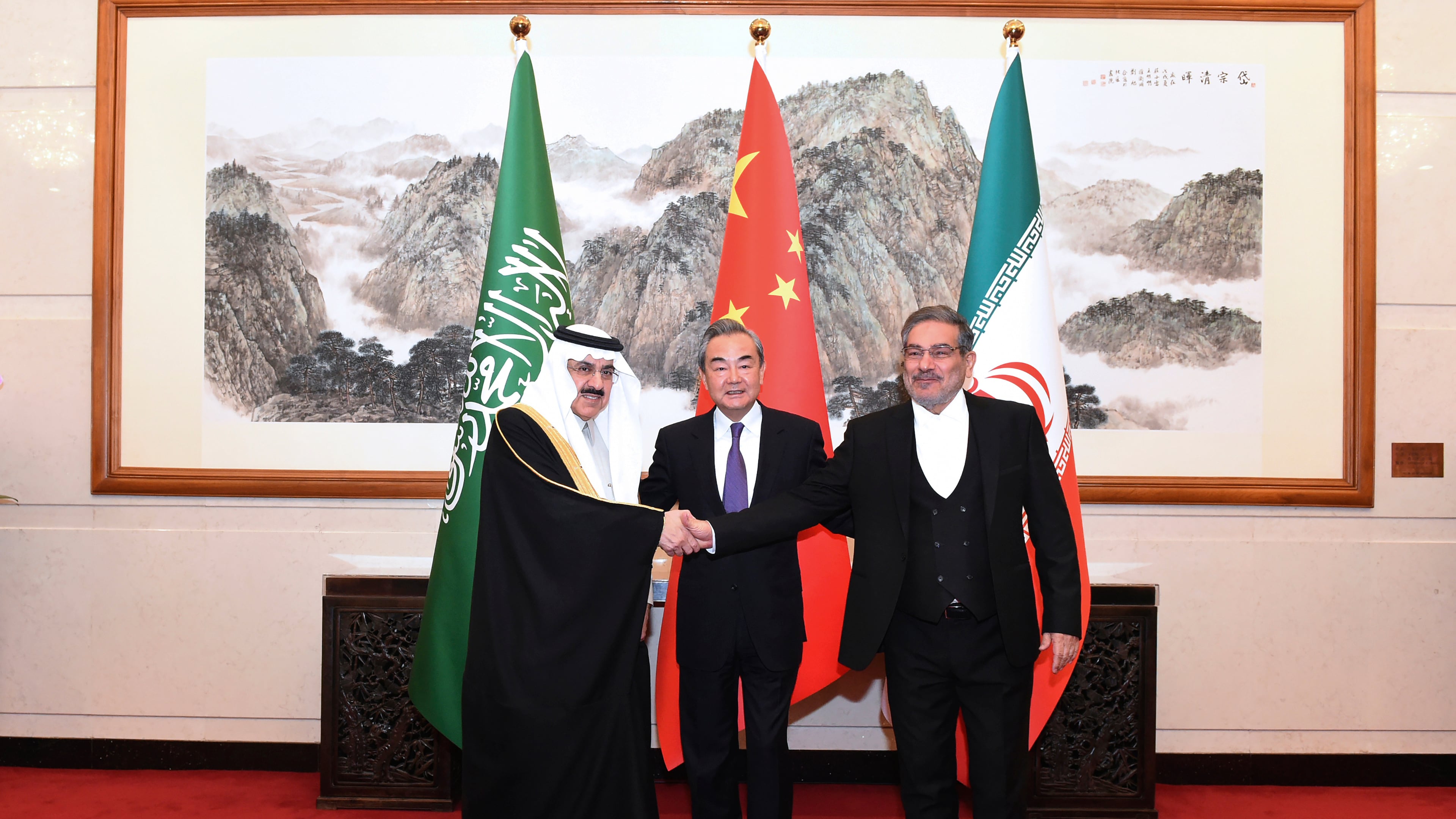 FILE - In this photo released by Xinhua News Agency, Ali Shamkhani, then secretary of Iran's Supreme National Security Council, right, shakes hands with Saudi national security adviser Musaad bin Mohammed al-Aiban, left, as Wang Yi, China's most senior diplomat, looks on for a photo during a closed meeting held in Beijing, on March 11, 2023. (Luo Xiaoguang/Xinhua via AP, File)