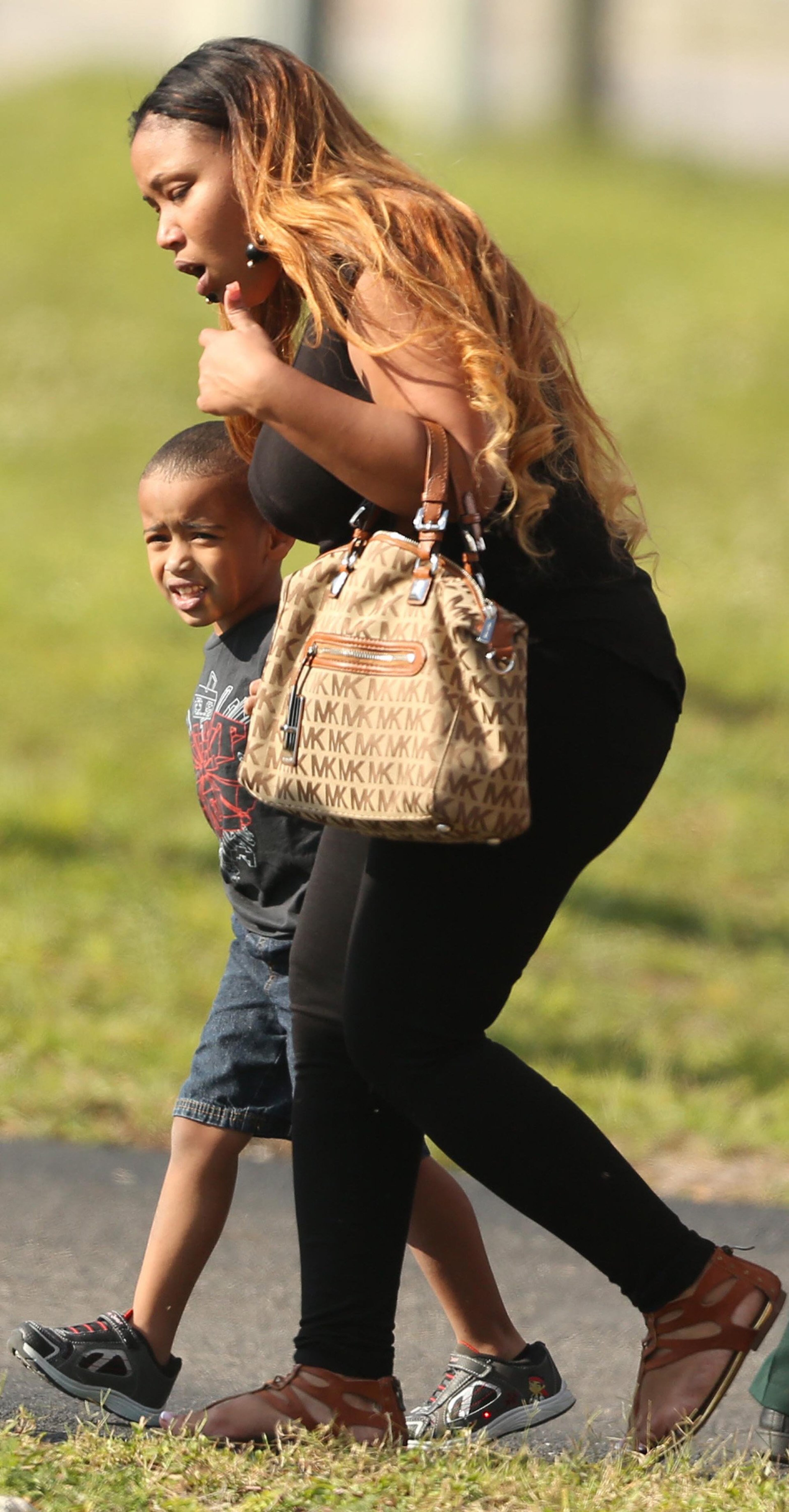 Children are escorted by their parents from the KinderCare Learning Center in Winter Park, Fla. (Stephen M. Dowell, Orlando Sentinel/MCT)