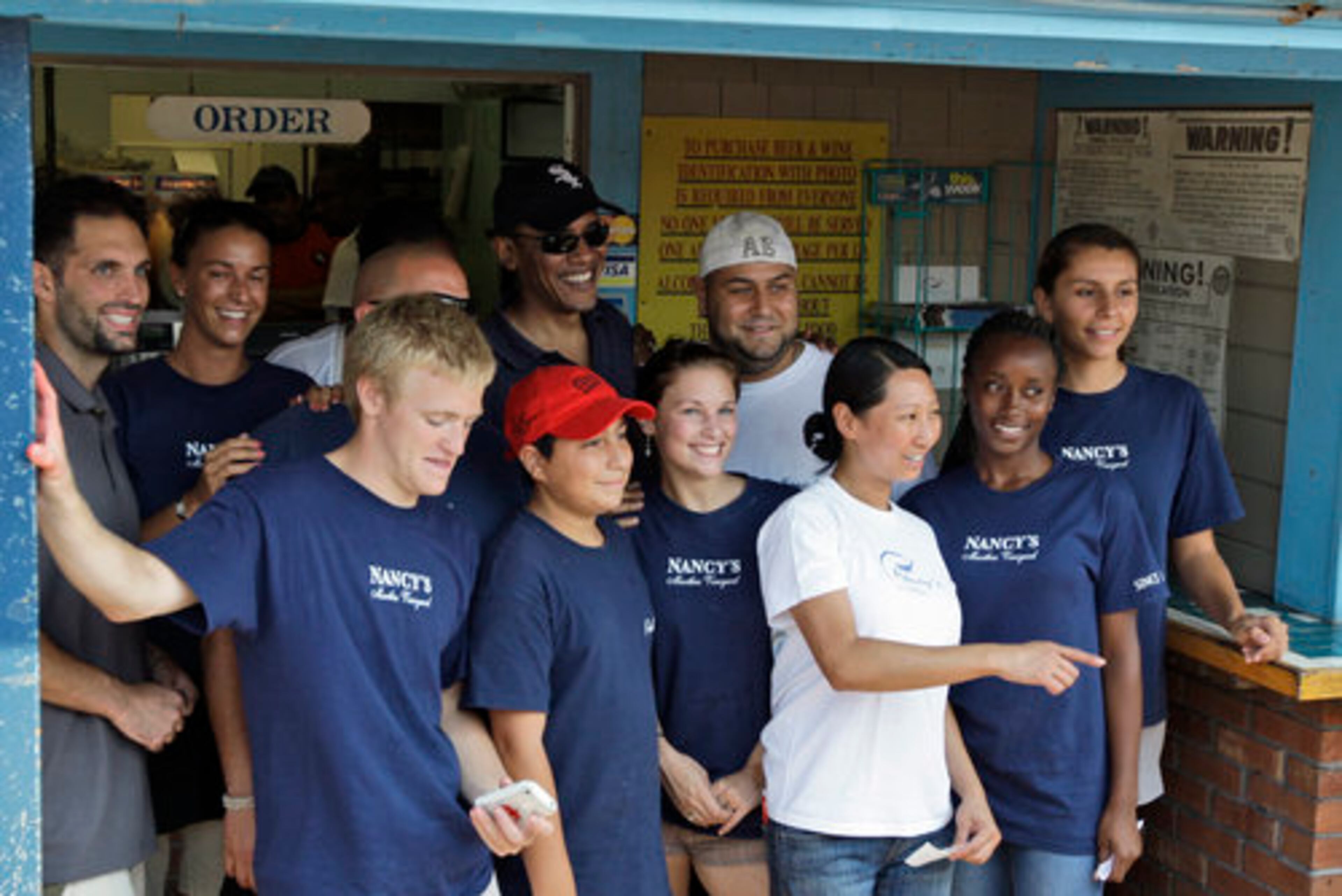 President Obama poses for a group photo while he gets lunch at Nancy's in Oak Bluffs, Mass.