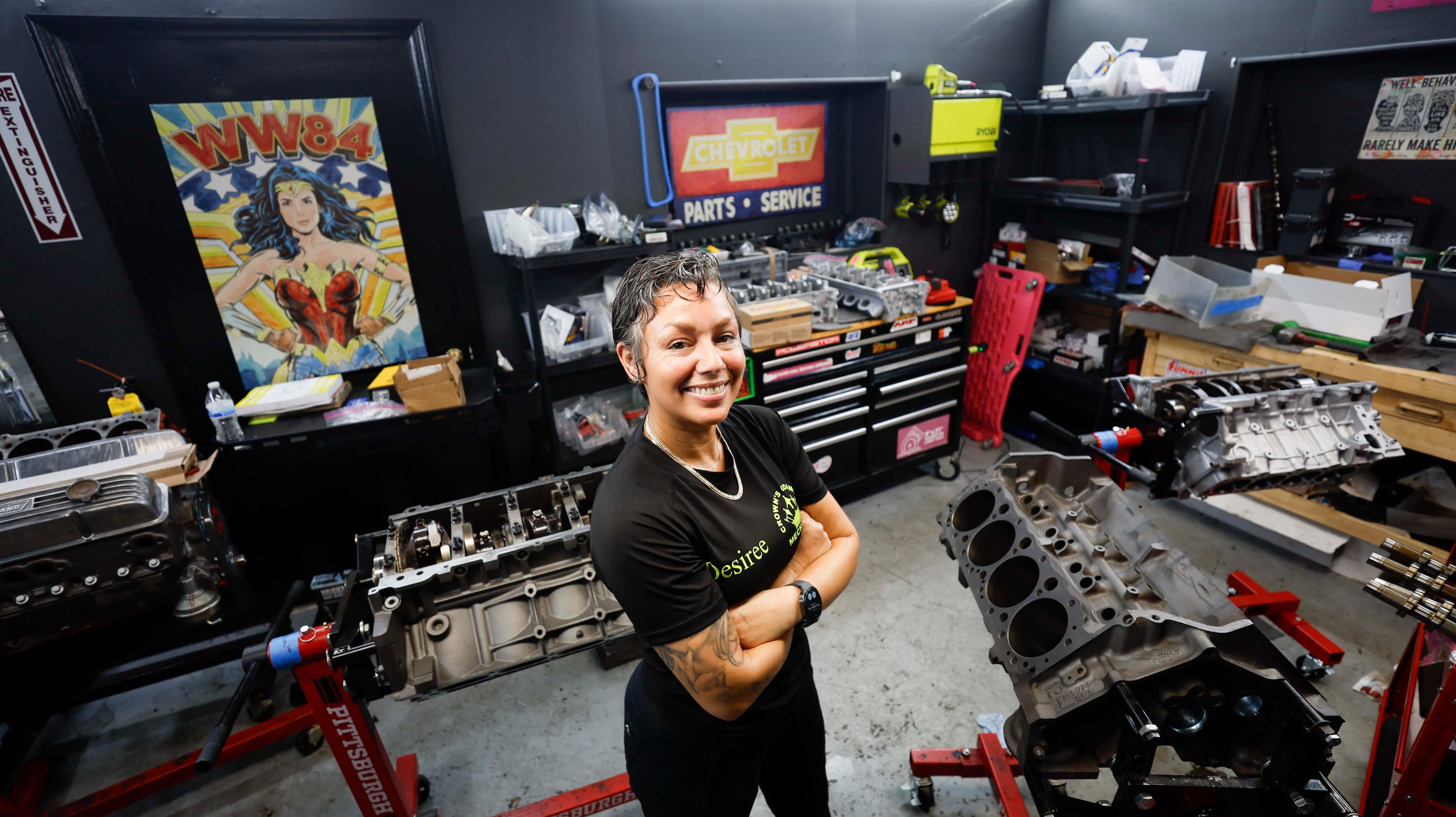Desiree White, owner of Crown’s Corner Mechanics, stands in the engine room of her Conyers shop. (Miguel Martinez/AJC)